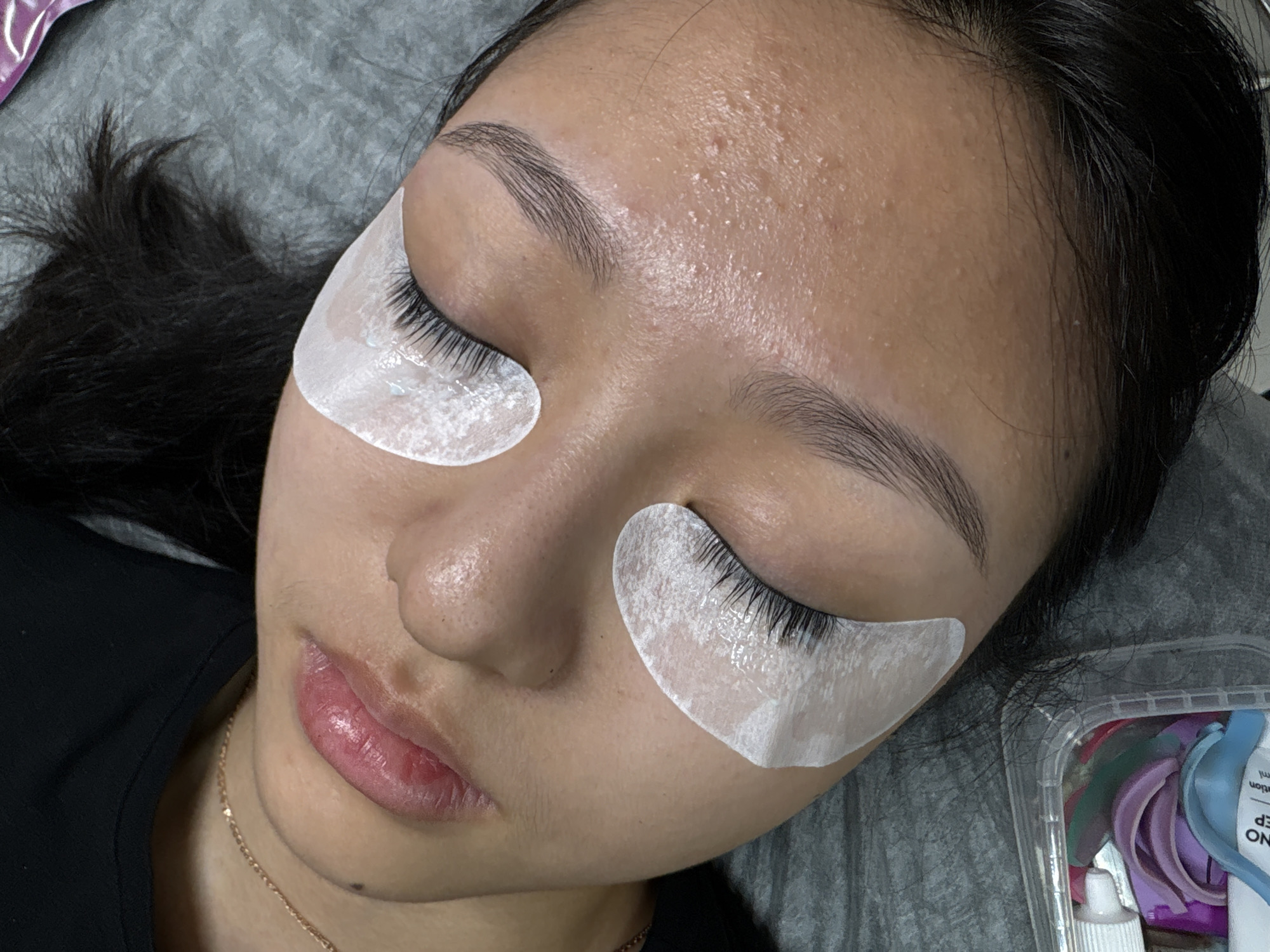 Woman receives eyelash extensions at Perm beauty salon