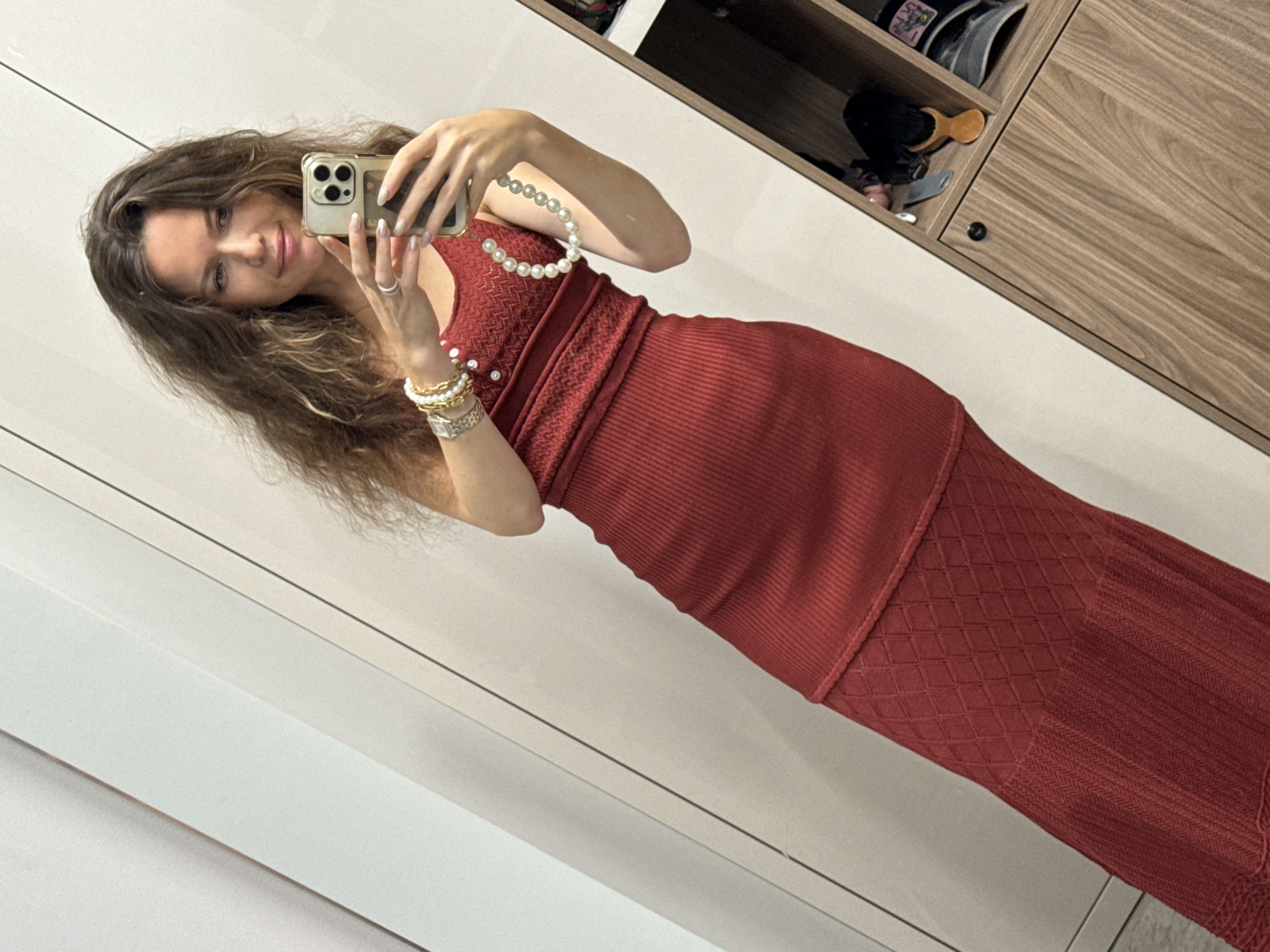 Red knit dress mirror selfies in a minimalist dressing space