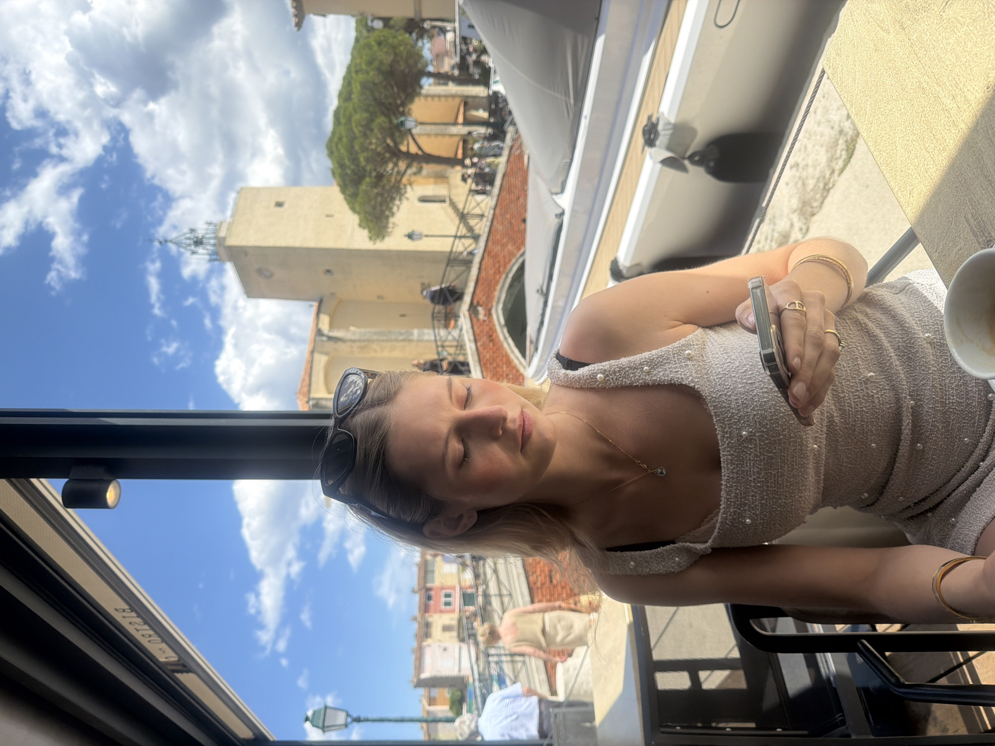 Woman dines at canal-view restaurant in Grimaud, France