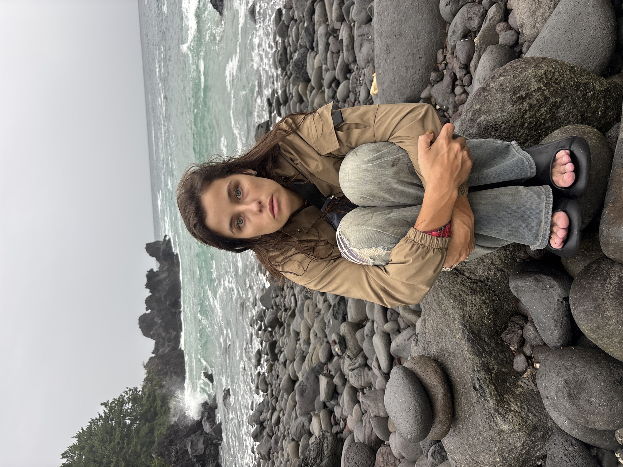 Hanging out on Jeju's rugged volcanic coastline on an overcast morning