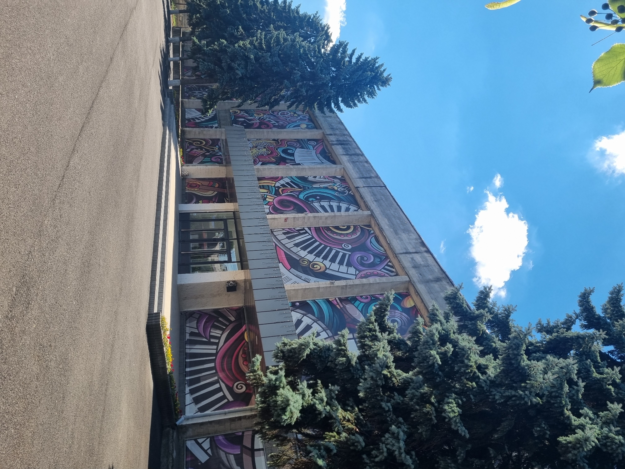 Vibrant musical murals cover the facade of a city building