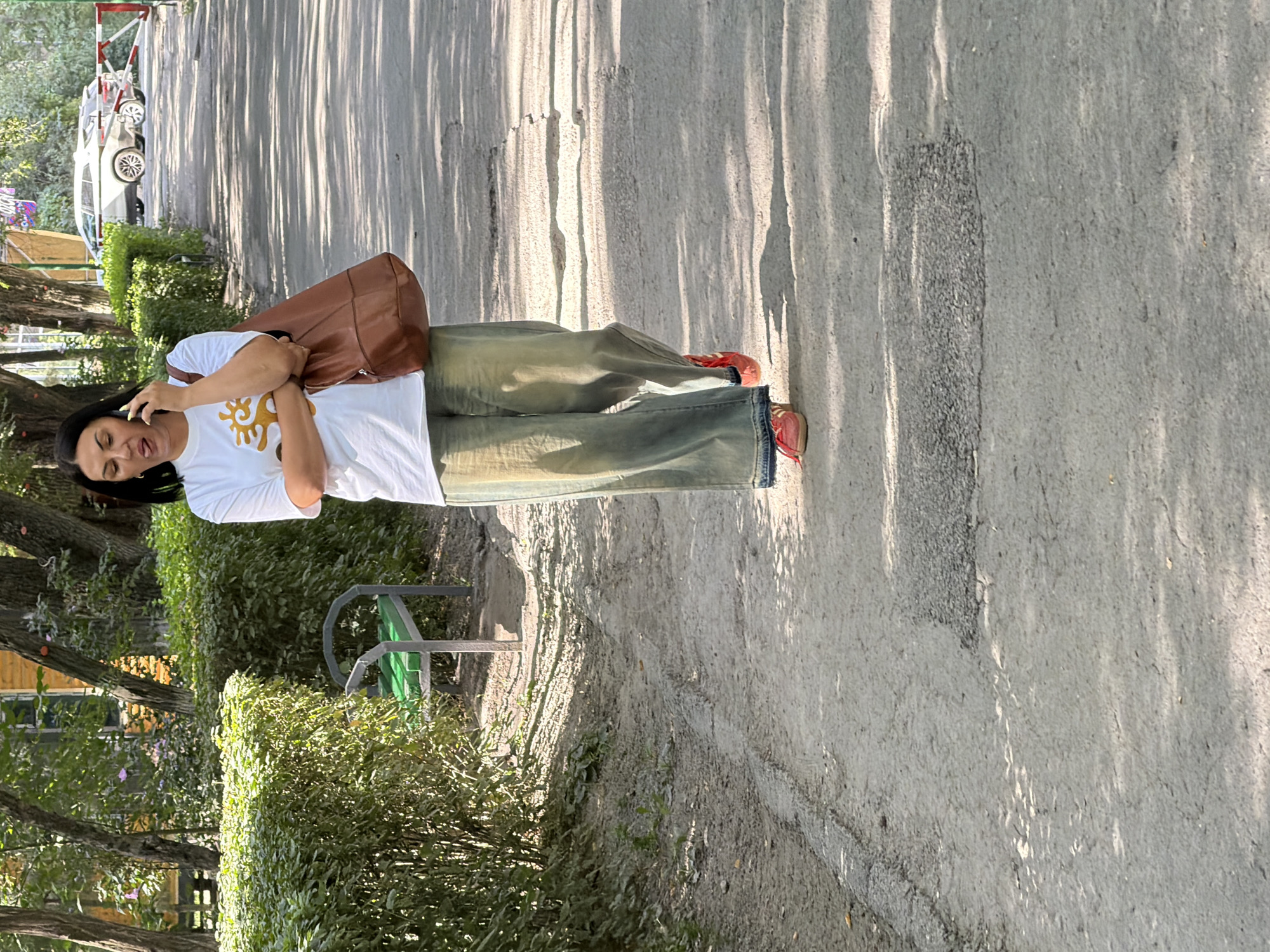 People walking paved outdoor paths, mix of casual and work attire