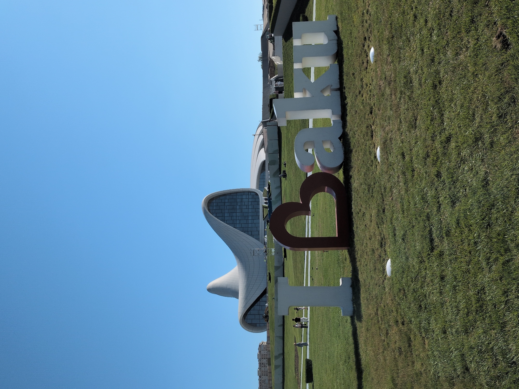 Sunny day around Baku's landmark sign and curved white building