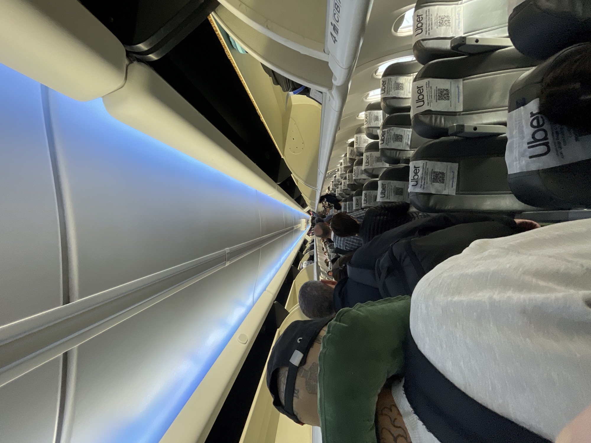 Passenger photographs airplane cabin interior near Ushuaia