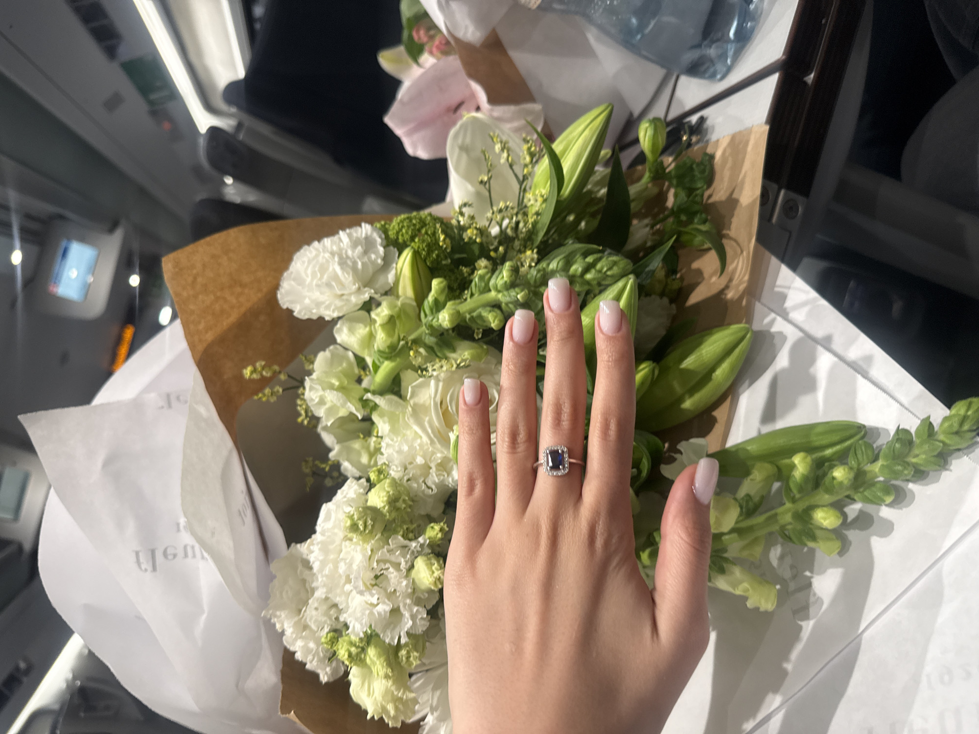 Engagement ring photographed with flower bouquets in Domodossola