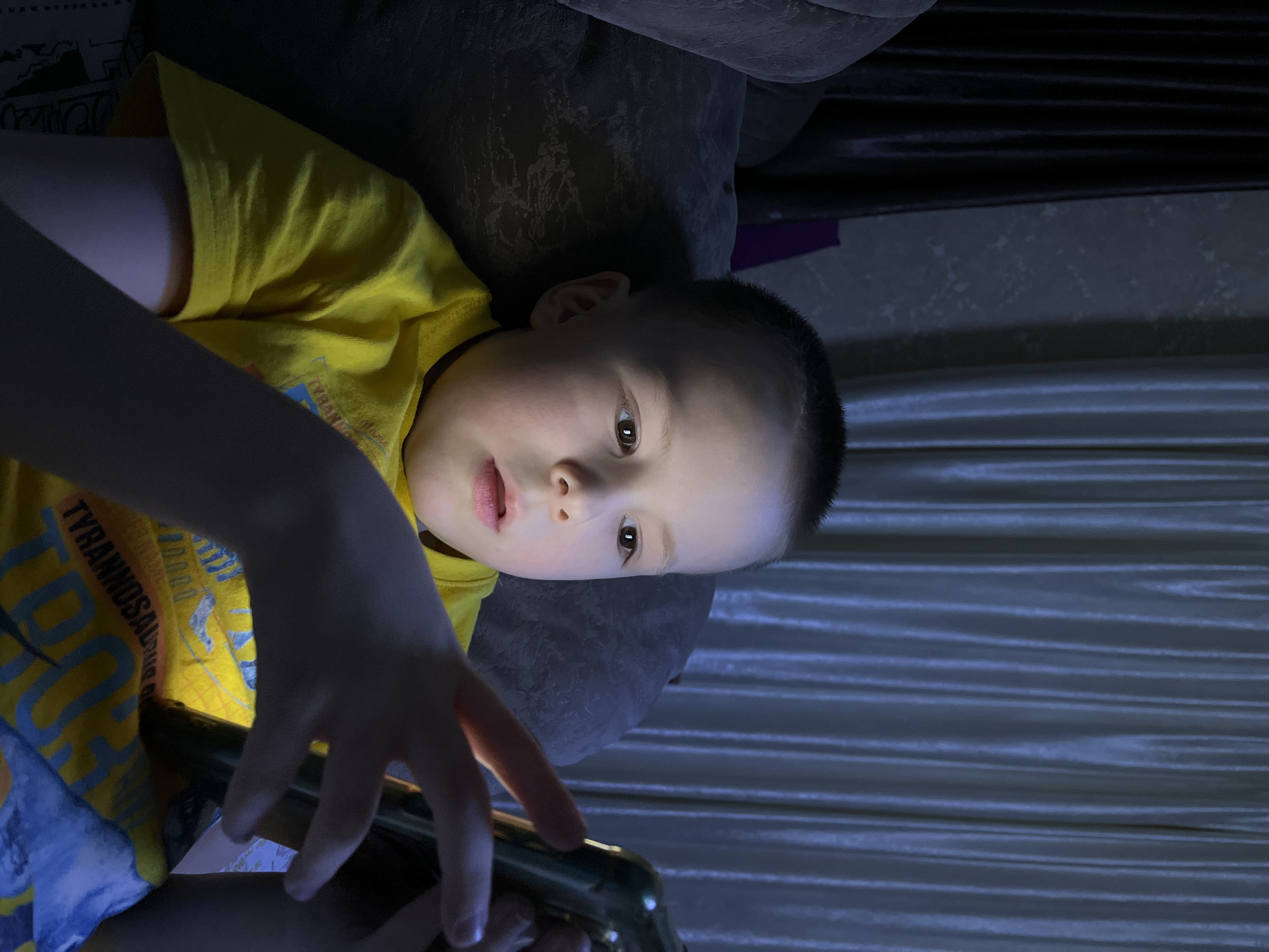 Child uses mobile phone on sofa in Usman, Russia