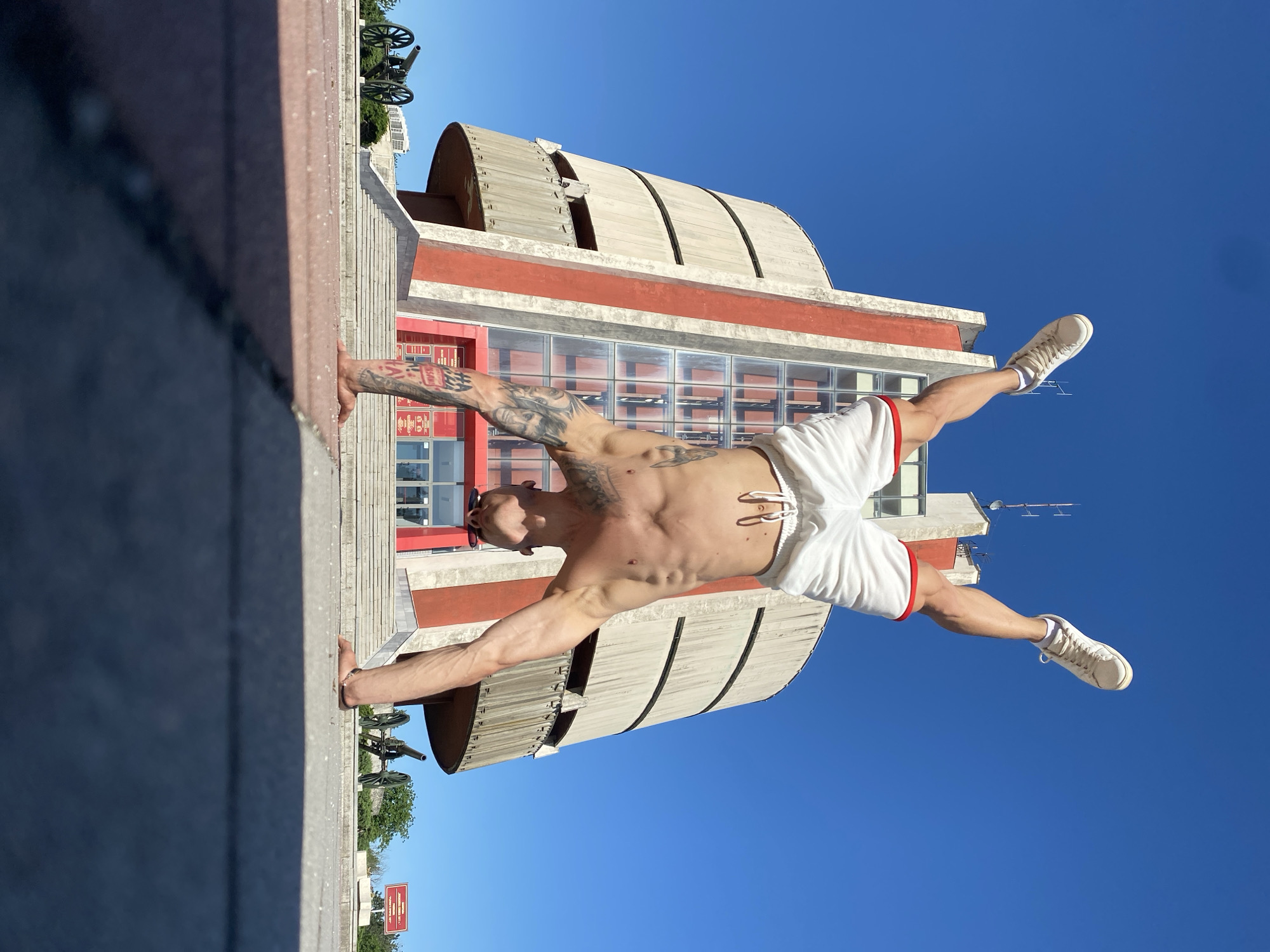 Man performs handstands at Bulgarian war memorial, plays with cat