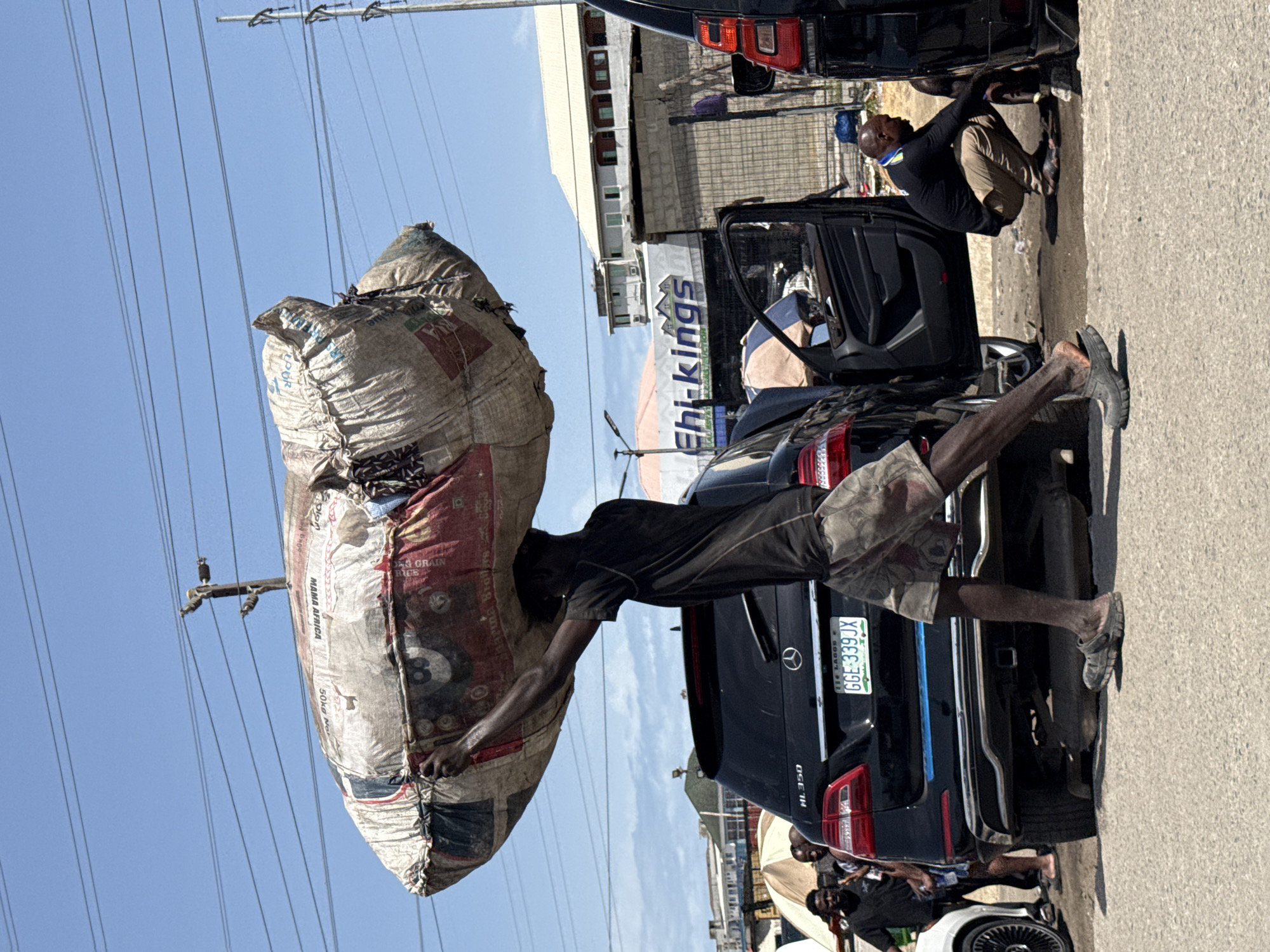 Man carries goods near shipping container in Igboefon, Nigeria