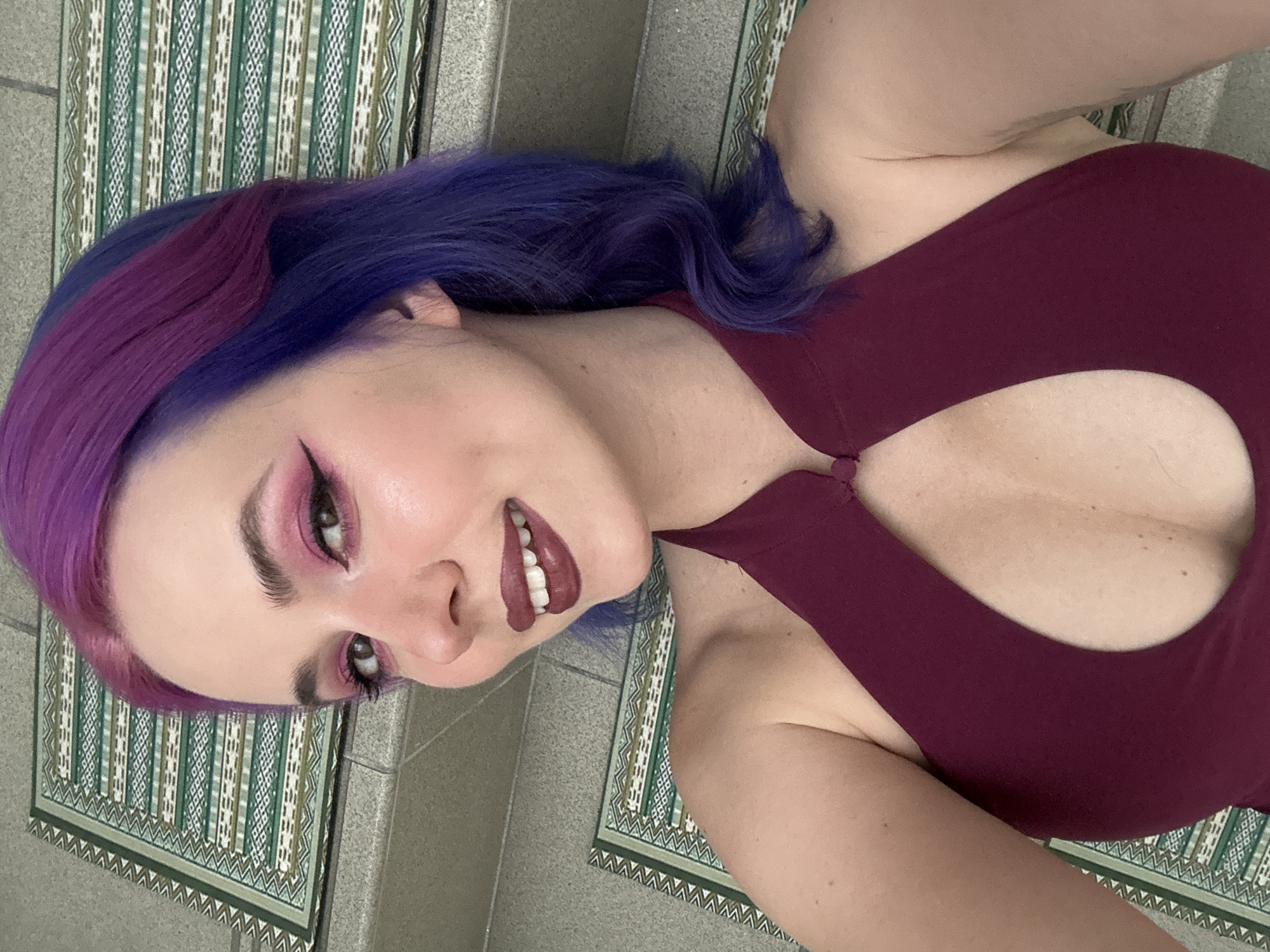 Woman with colorful hair takes selfies in Zagreb home