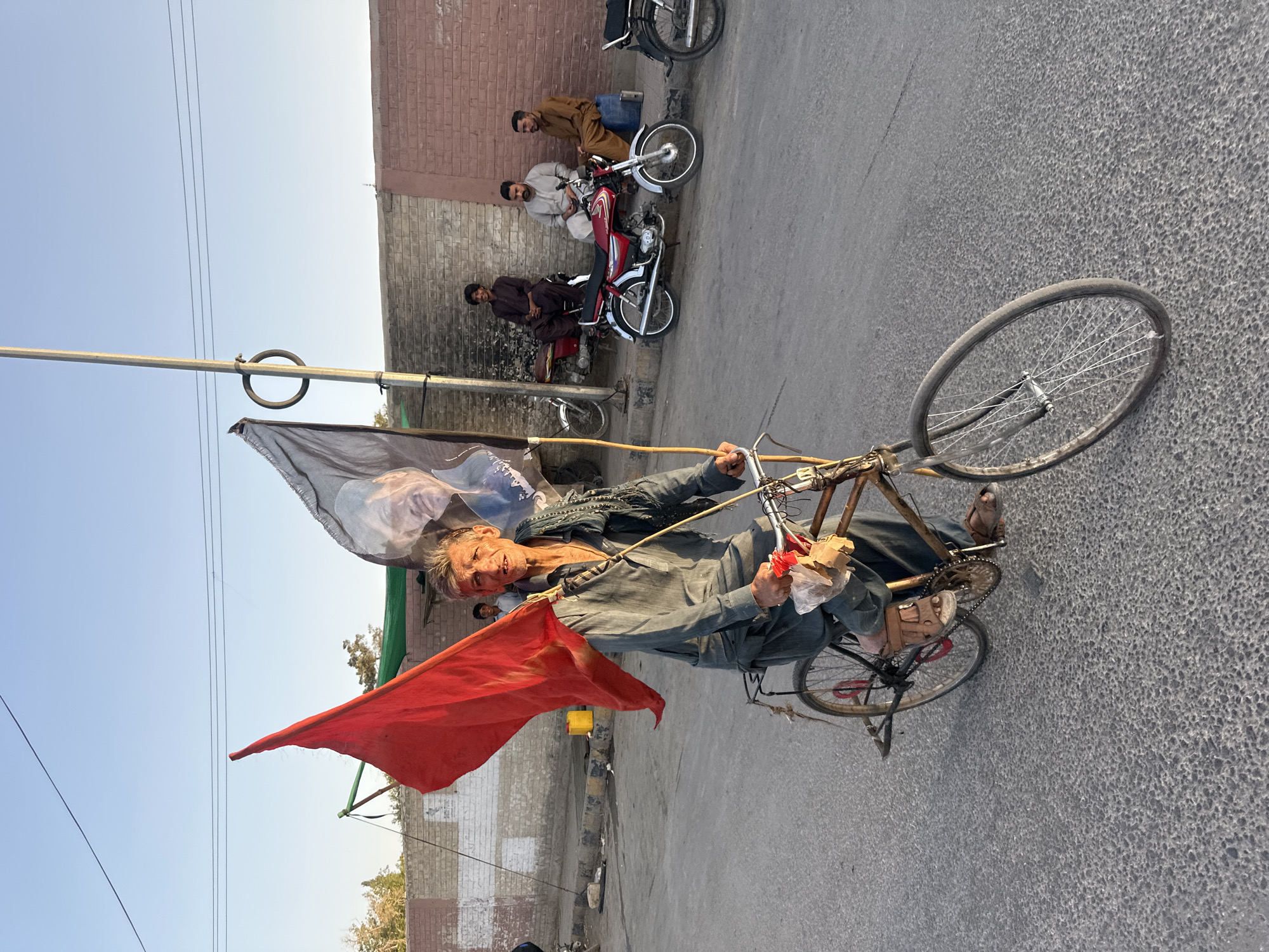 Political procession moves through Quetta streets with flags and vehicles