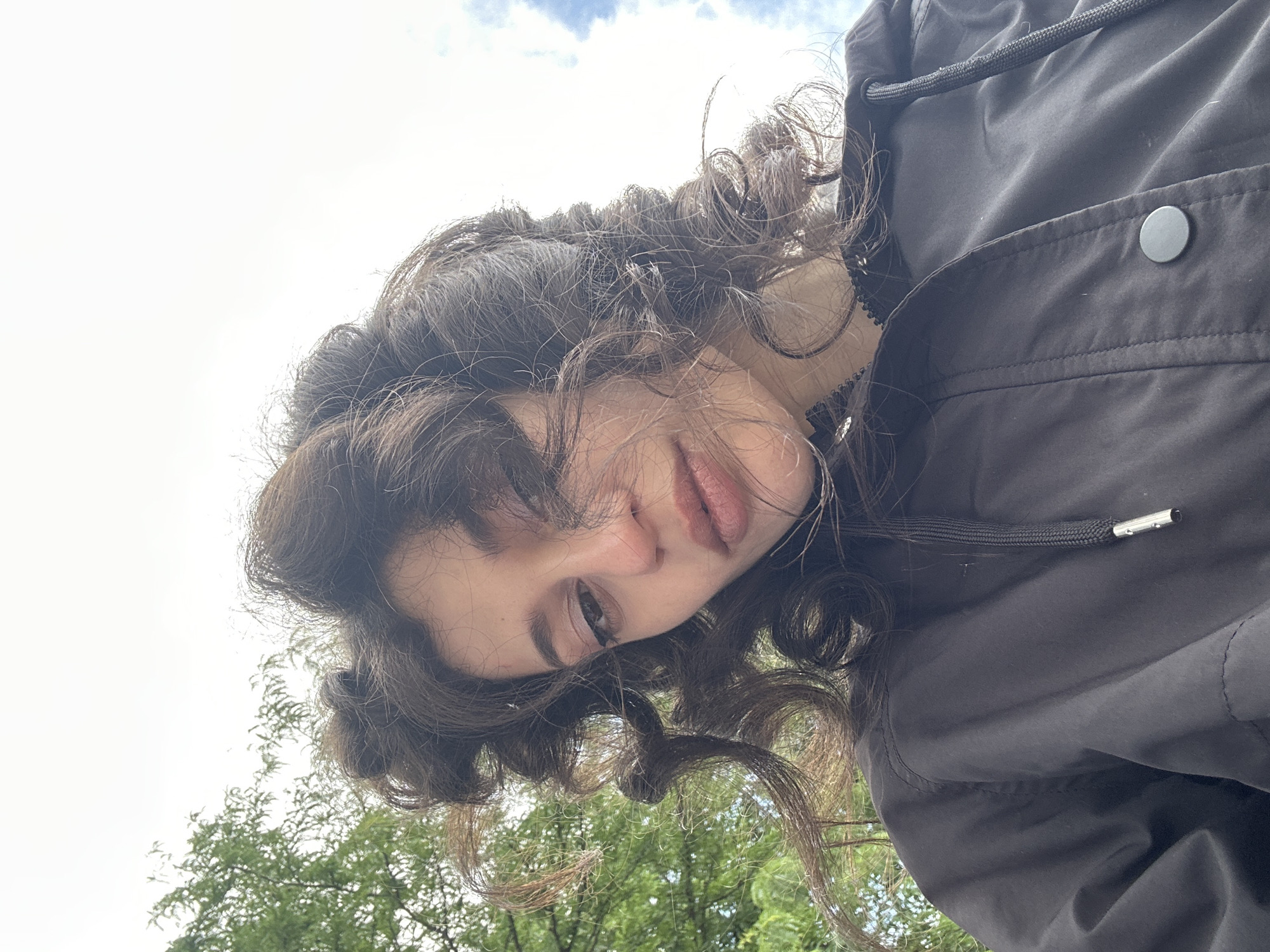 Woman takes selfies at Sofia playground during windy afternoon