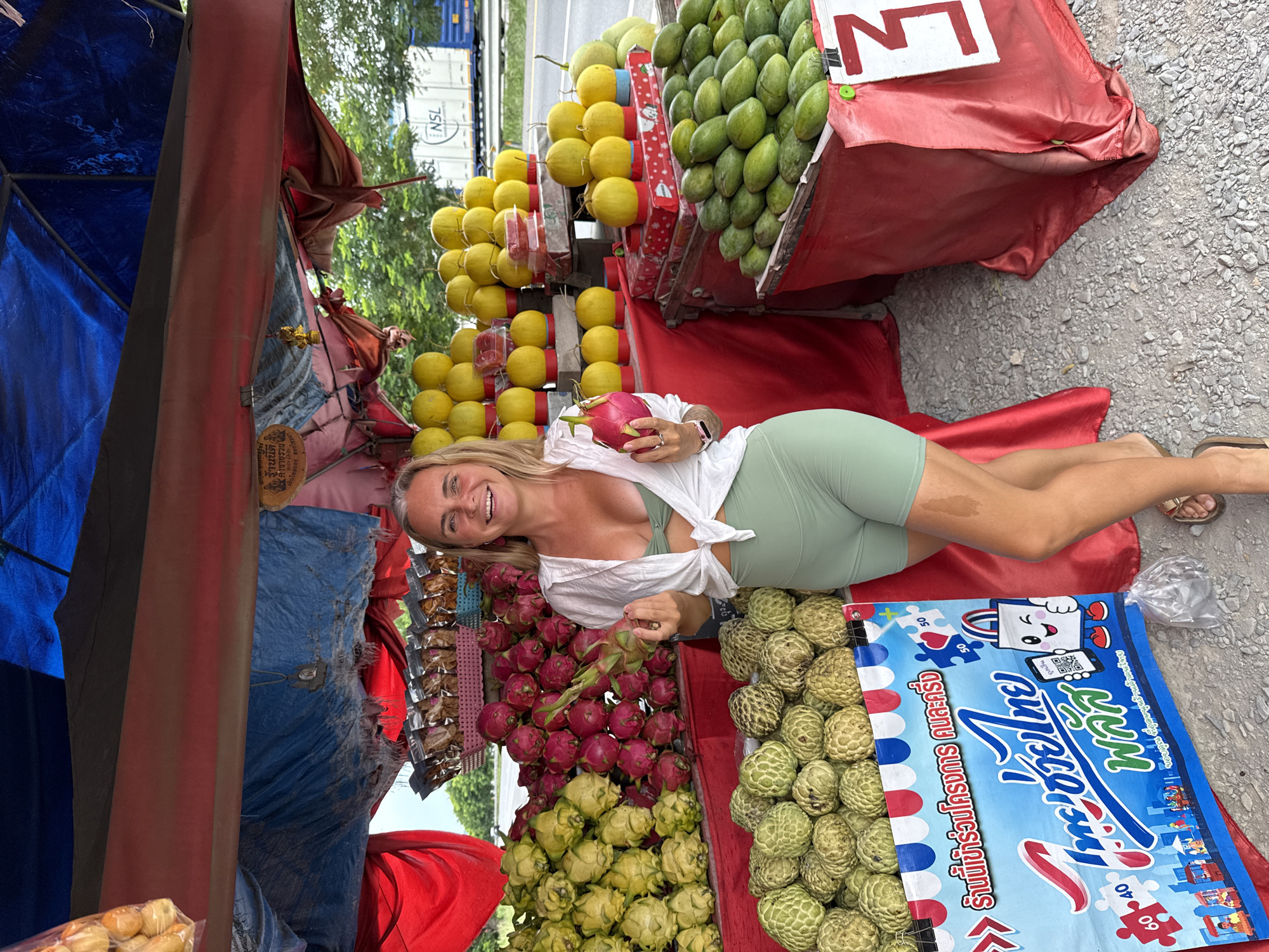 Colorful roadside fruit stand draws browsers in Rai Mai, Thailand