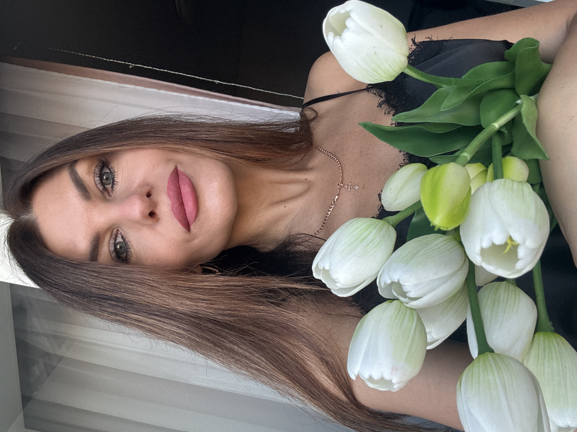 Woman with white tulips observed in Chaikovsky, Russia