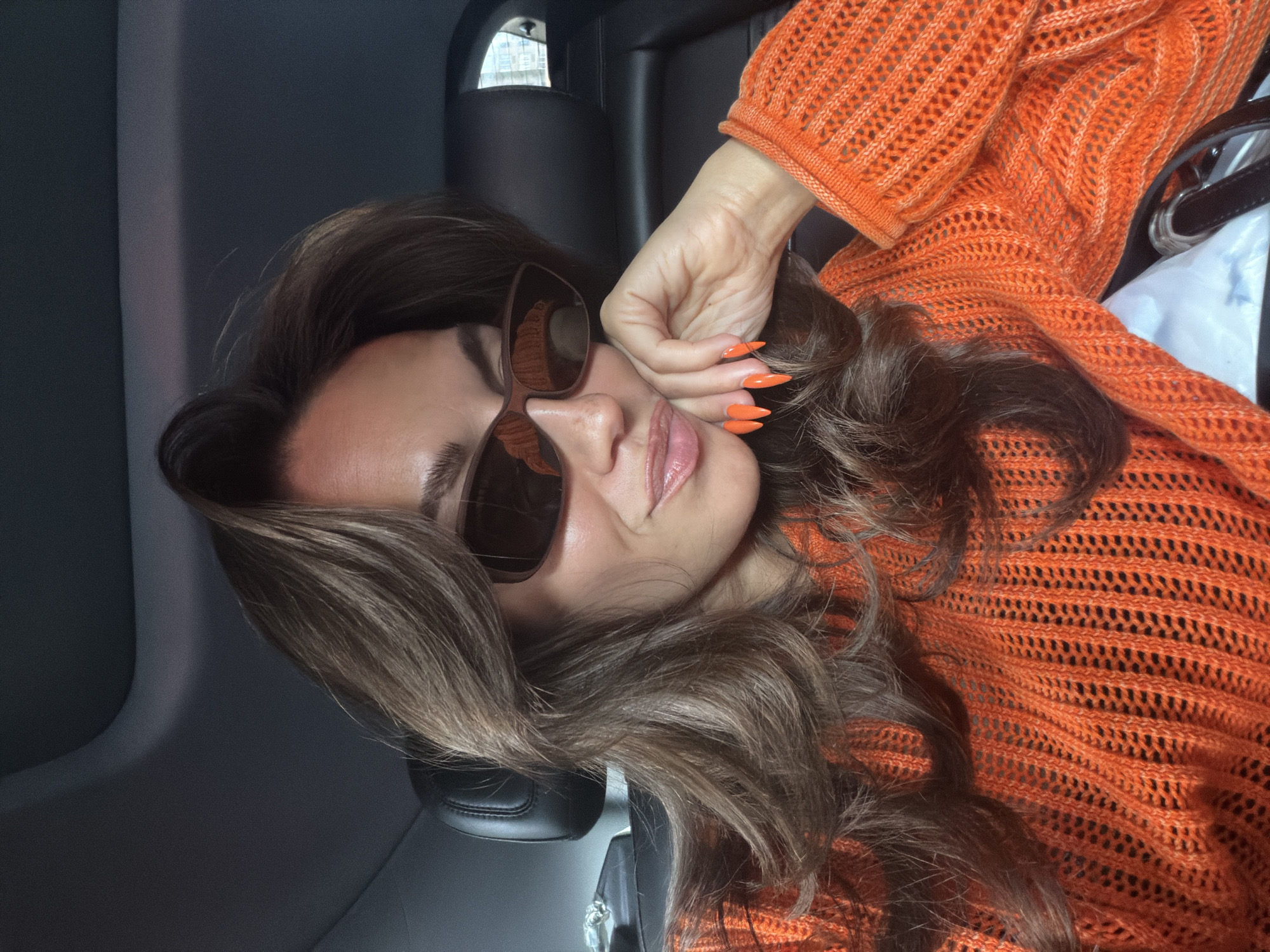 Person photographed posing in vehicle in New York