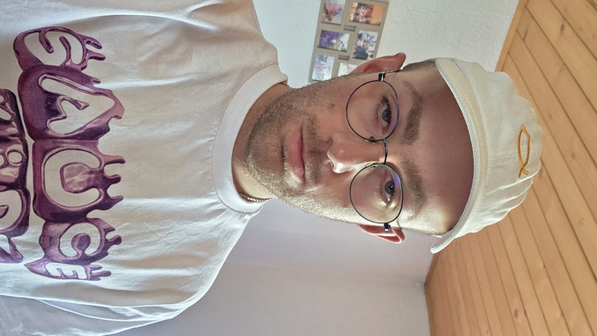 Casual close-up selfie, white baseball cap