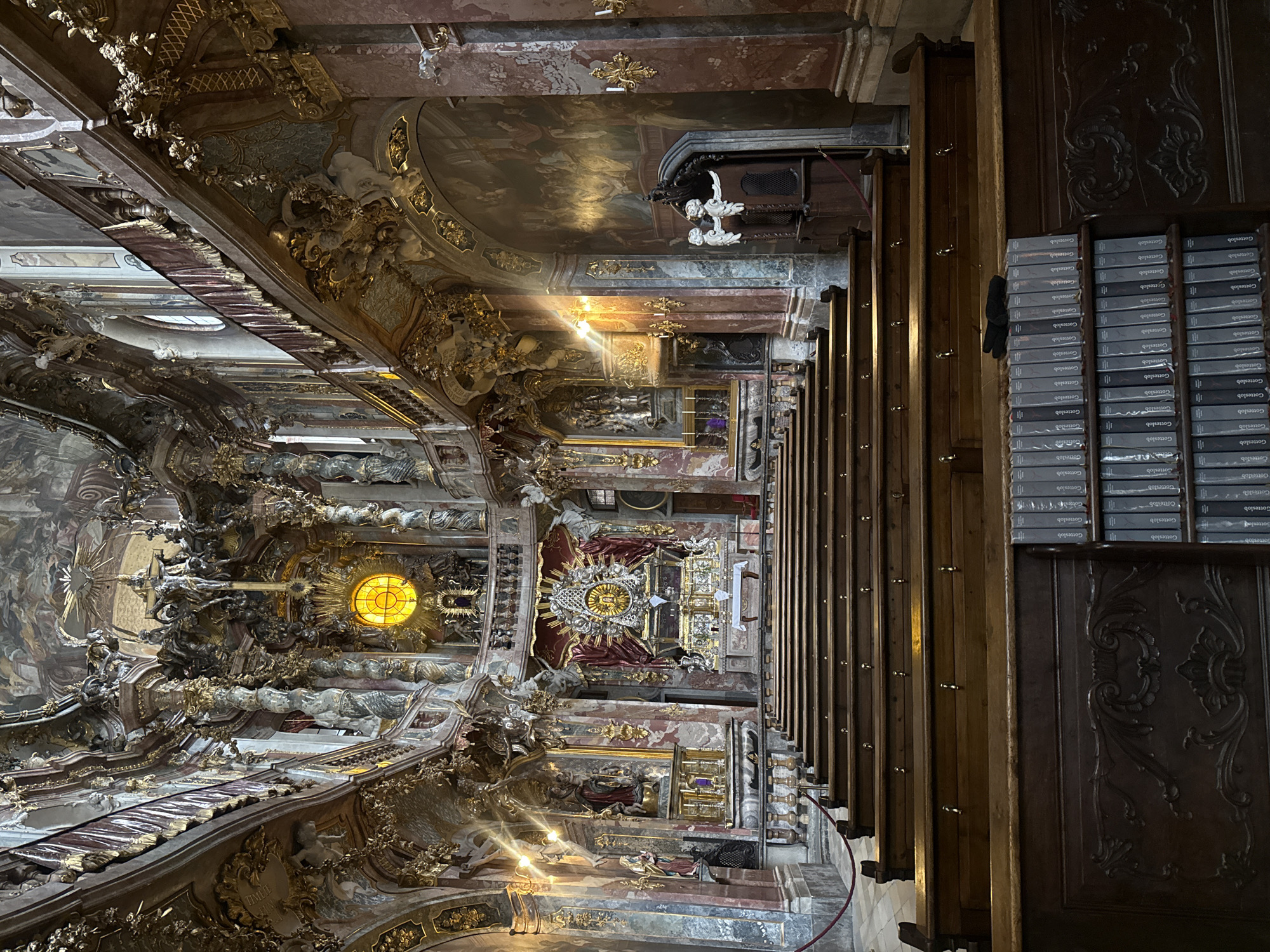 Tourists document ornate Asam Church interior in Munich