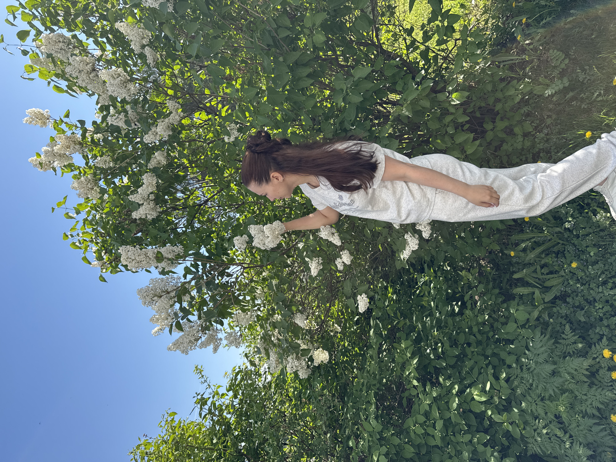 Woman enjoys spring morning with baby in Chaikovsky, Russia