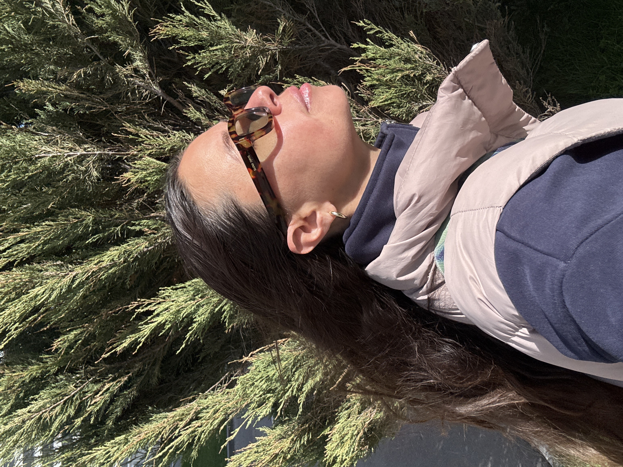 Woman rests in sunlit vegetation in Kazan