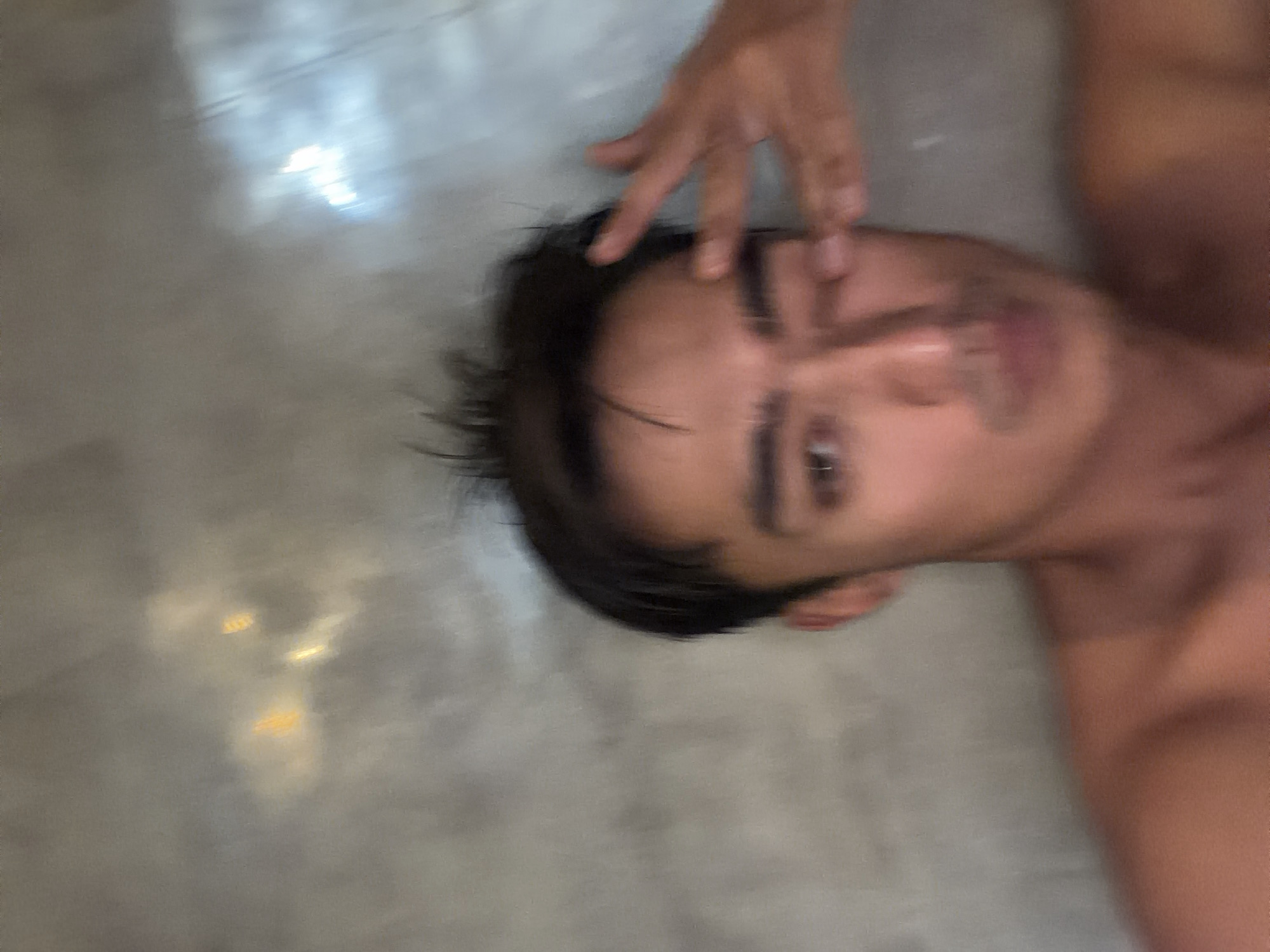 Person photographed resting on floor in Kediri, Indonesia