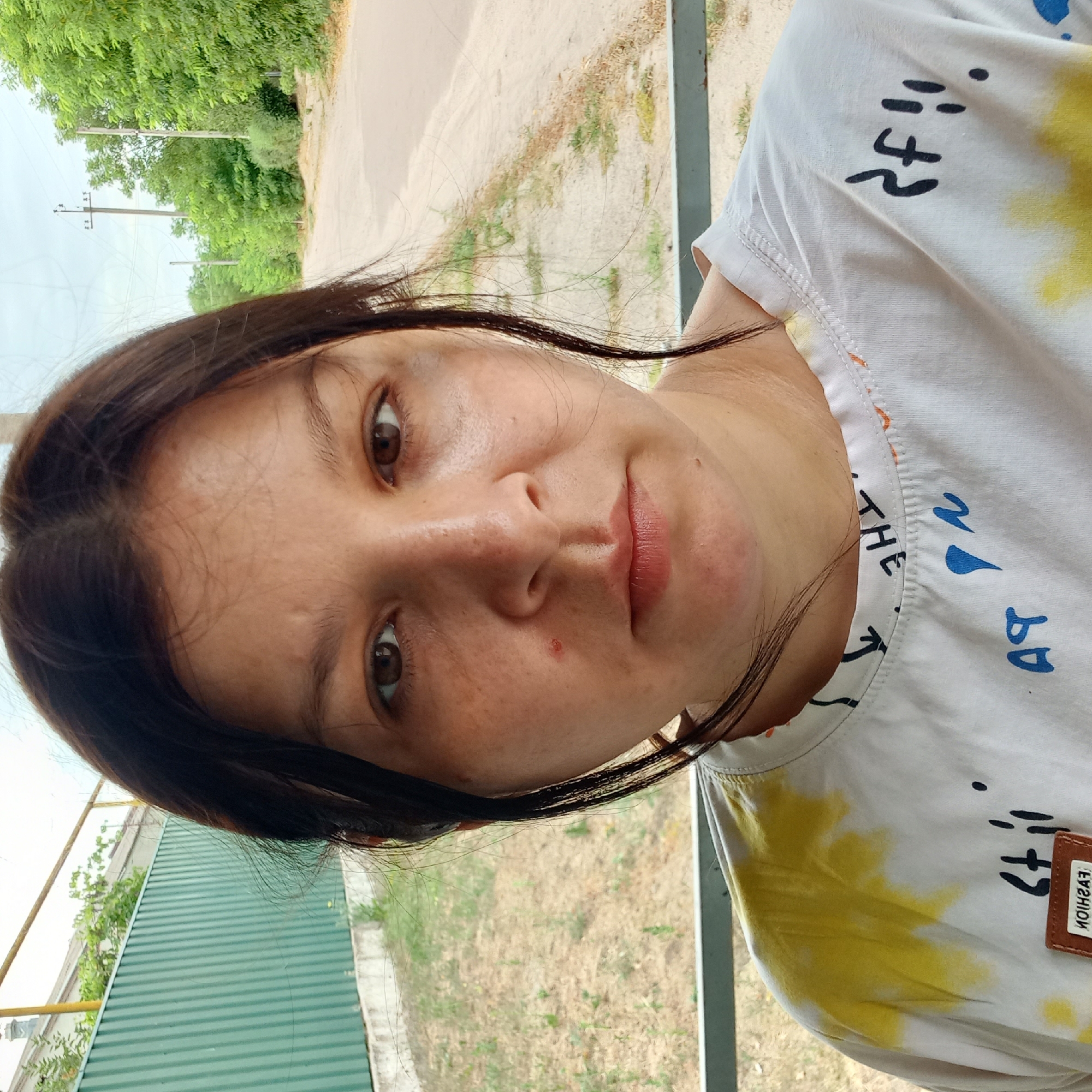 Multiple shots at a Klyntsi bus stop, same white graphic tee