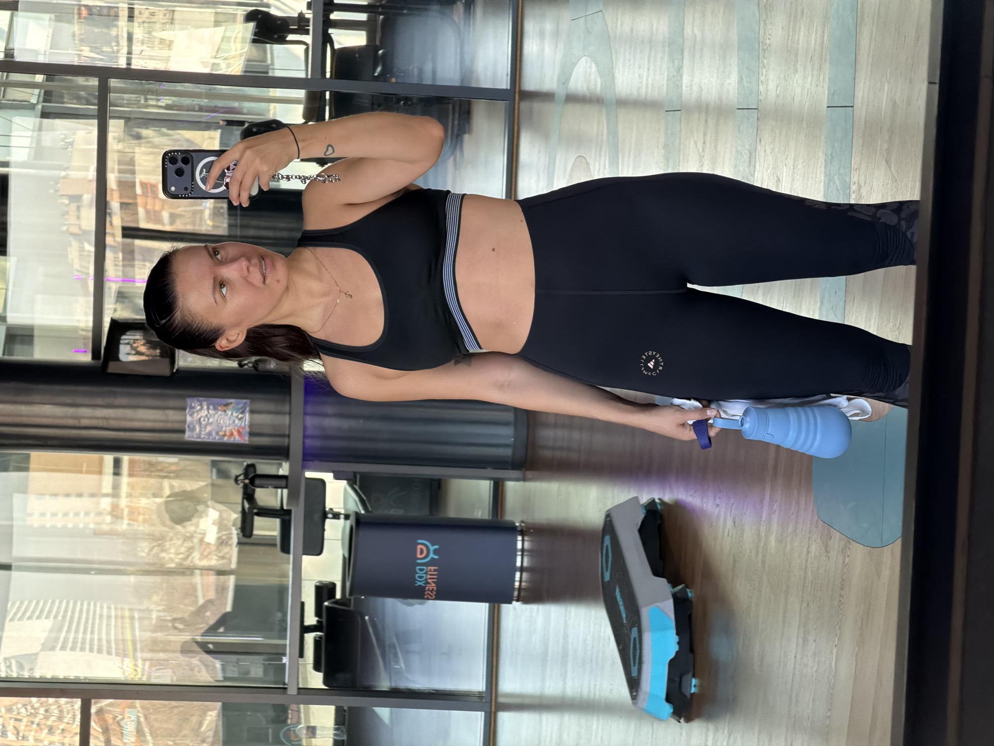 Woman takes mirror selfie at Moscow DDX Fitness gym