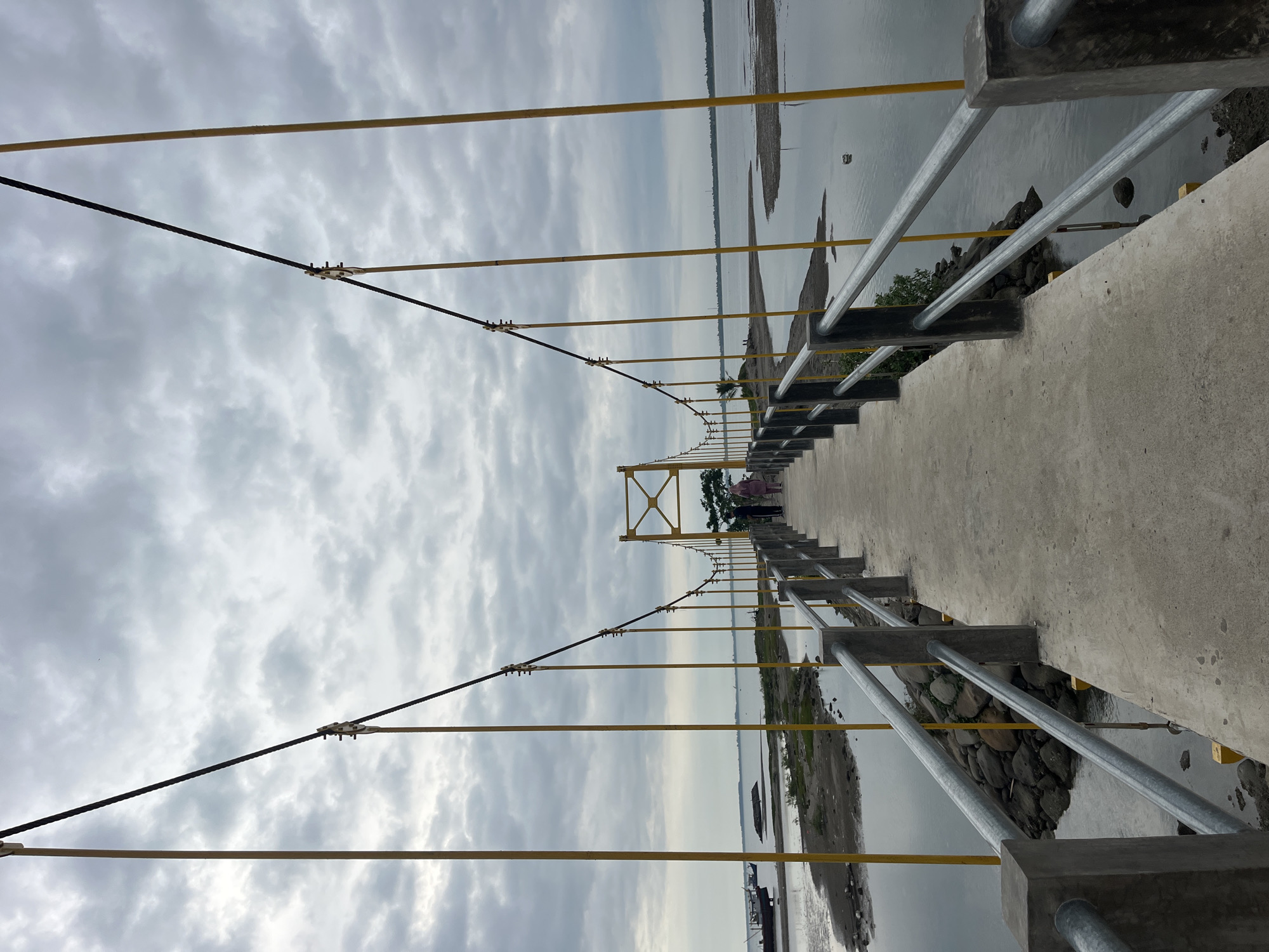 Suspension bridge observed spanning waterway in Lhokseumawe, Indonesia