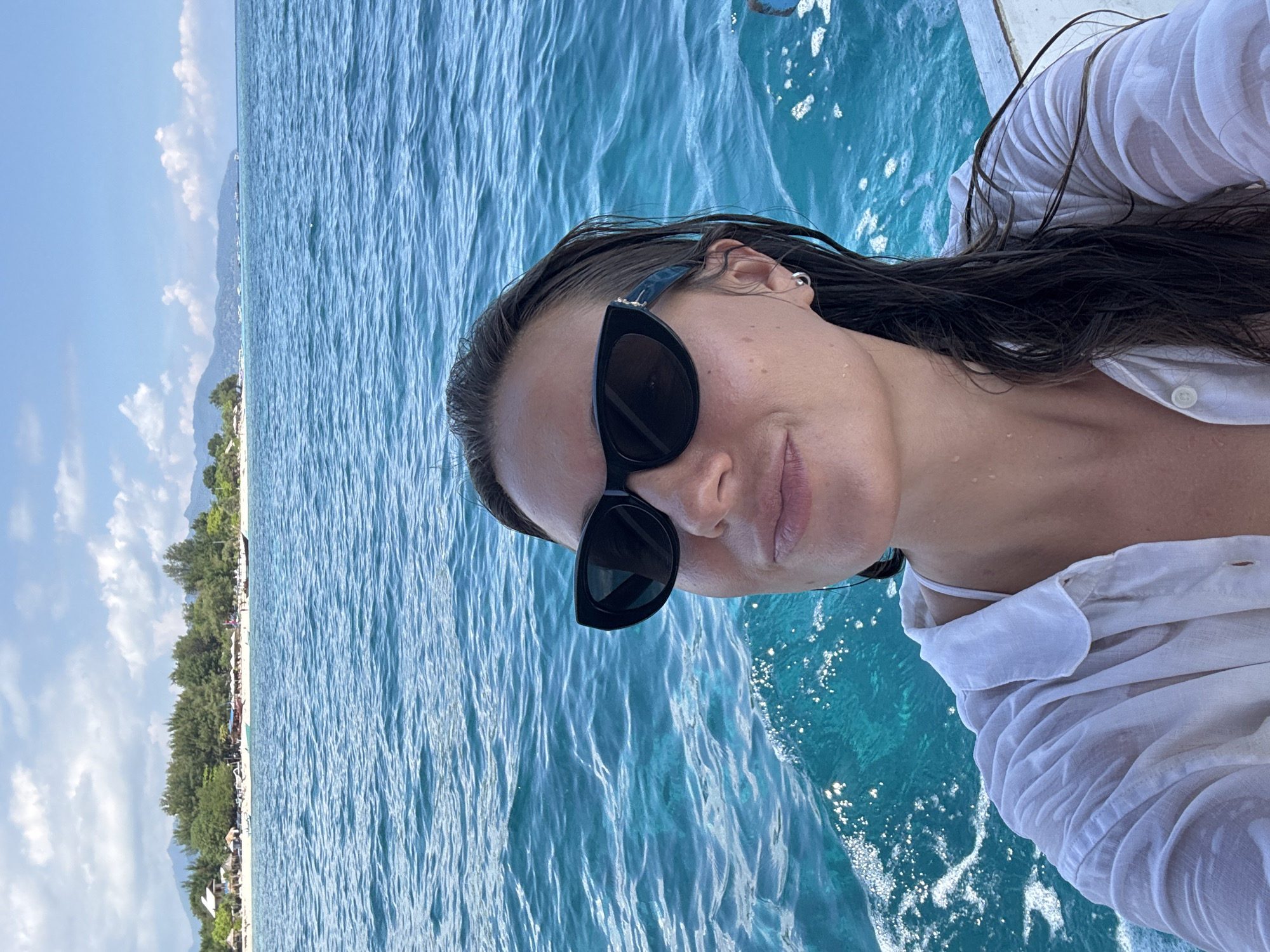 Woman enjoys boat trip in turquoise Indonesian waters
