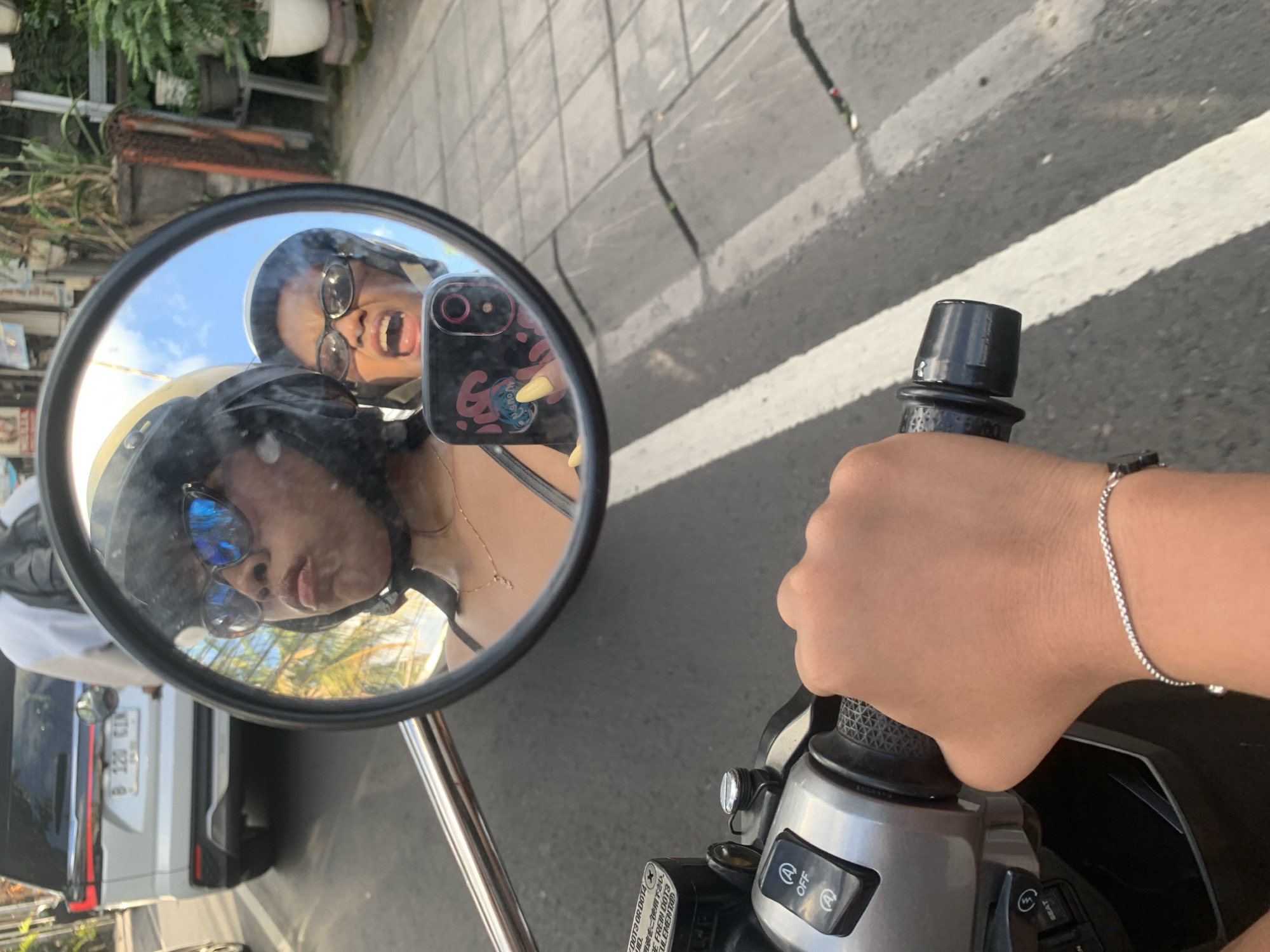 Busy North Kuta street scene: traffic, tangled wires, and local life