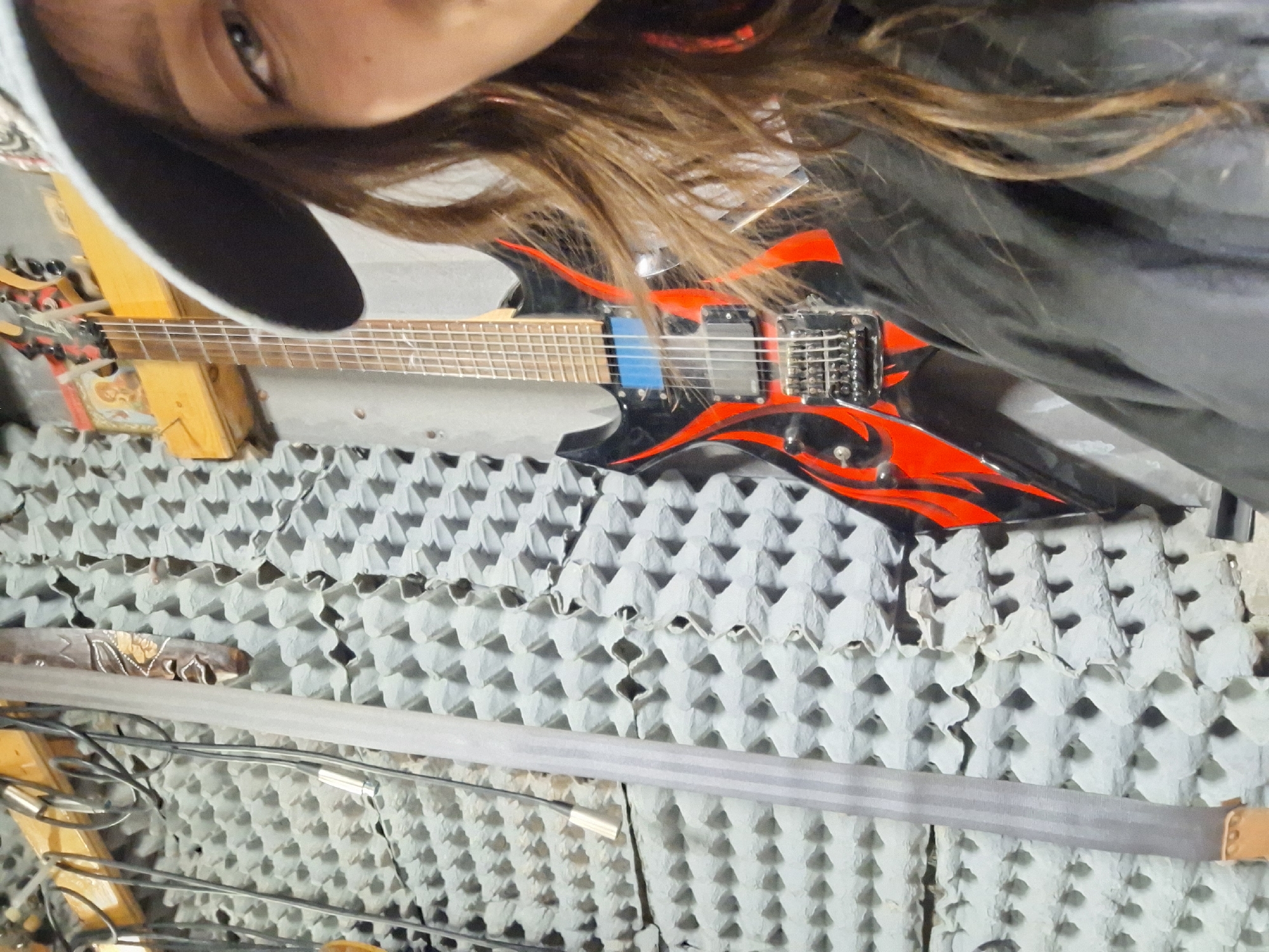 Musician photographed with guitar in Bulgarian rehearsal studio