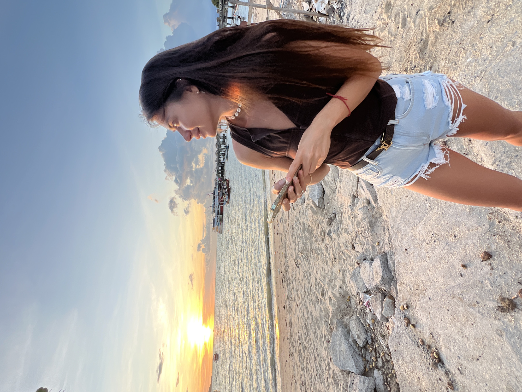 Sunset selfies and shoreline activity at Baan Bang Rak