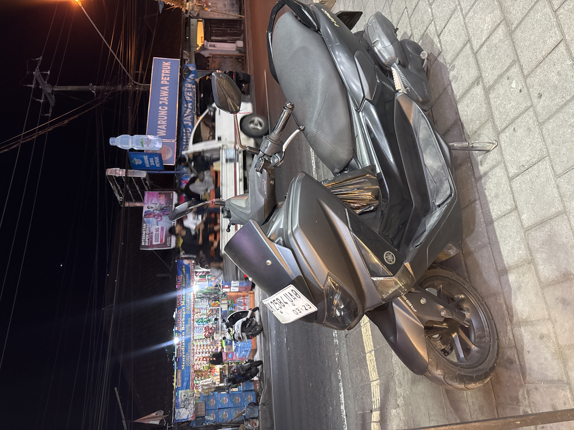 Nighttime street scenes around a Denpasar commercial strip