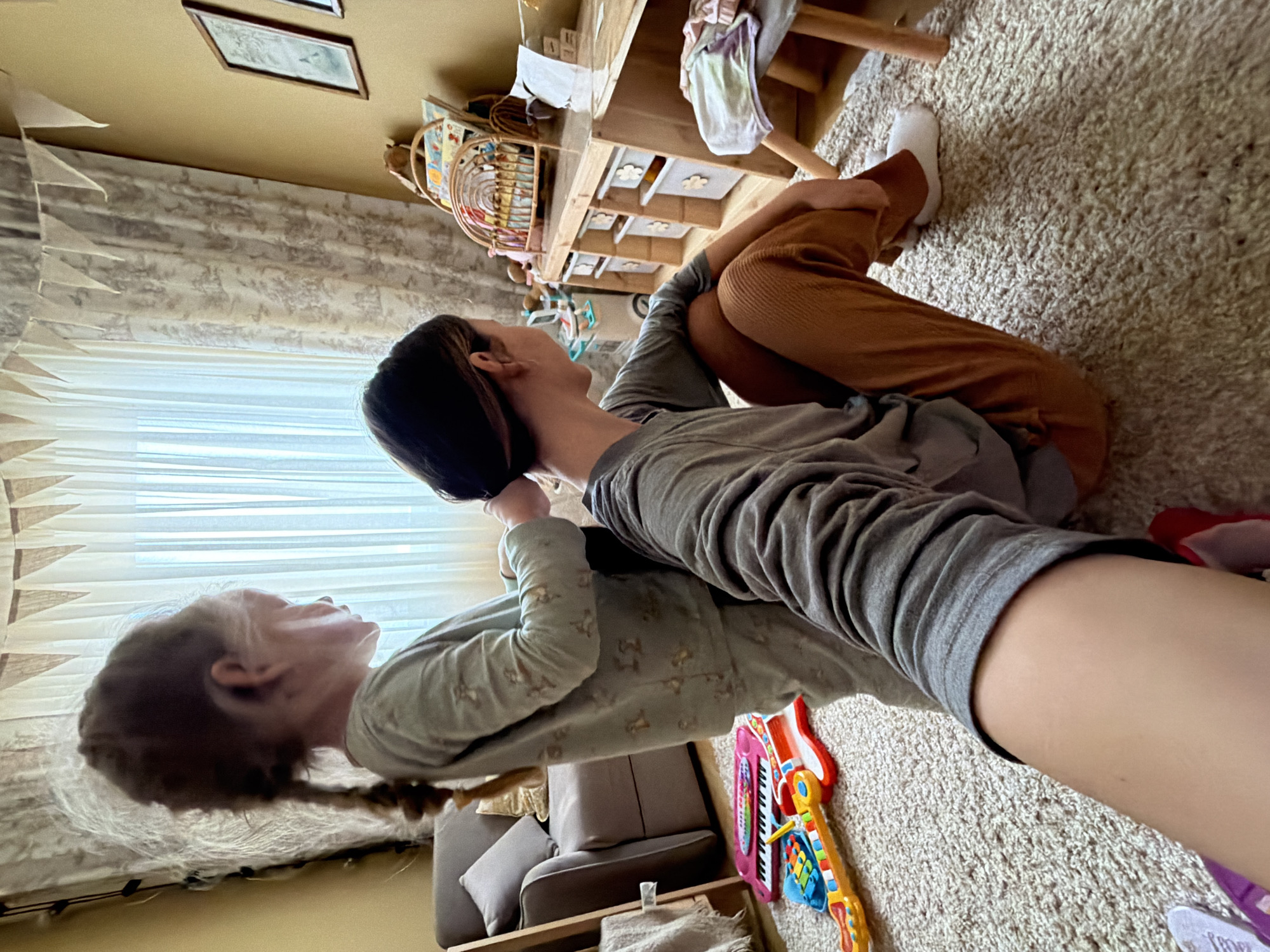 Girl plays with colorful parrot in Russian home