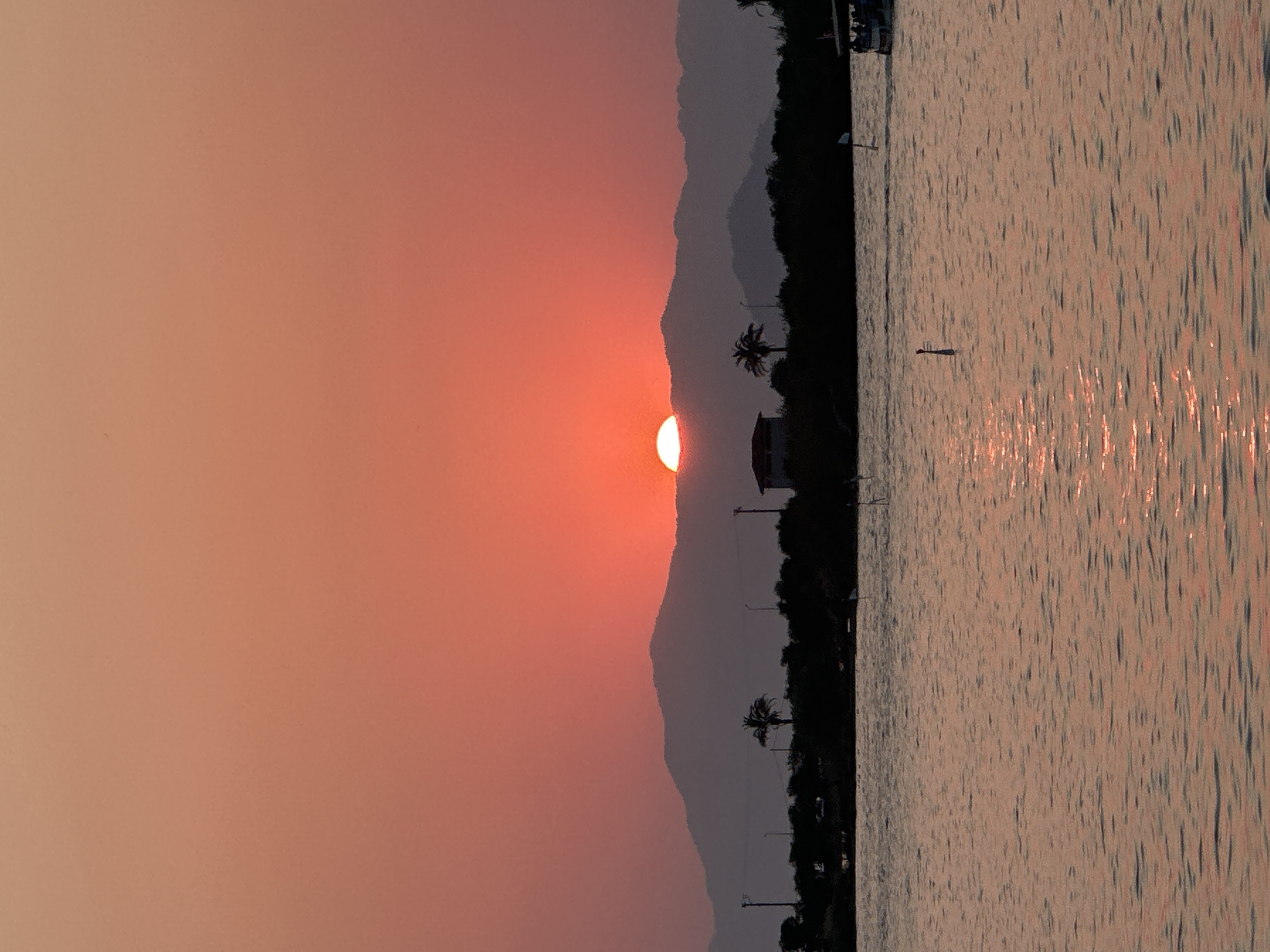 Golden hour over Fethiye Bay, sun sinking behind the mountains.