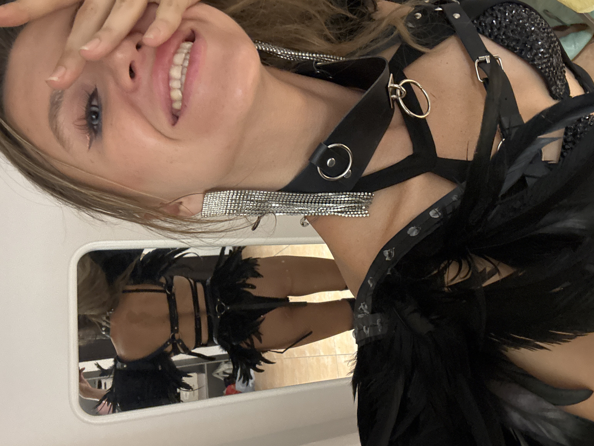Edgy feathered bodysuit look, captured in Bangkok mirror selfies
