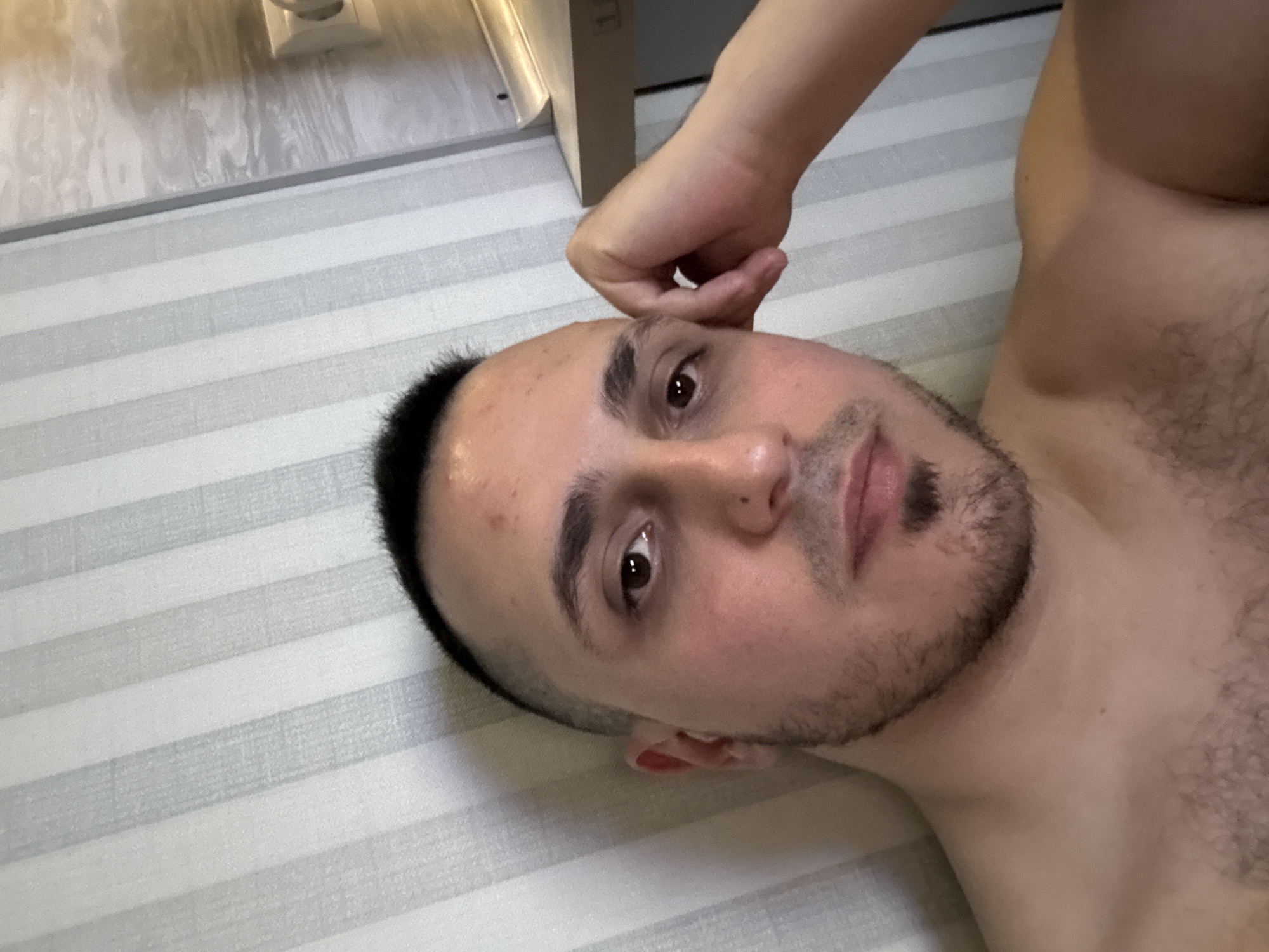 Young man takes indoor selfies from multiple angles