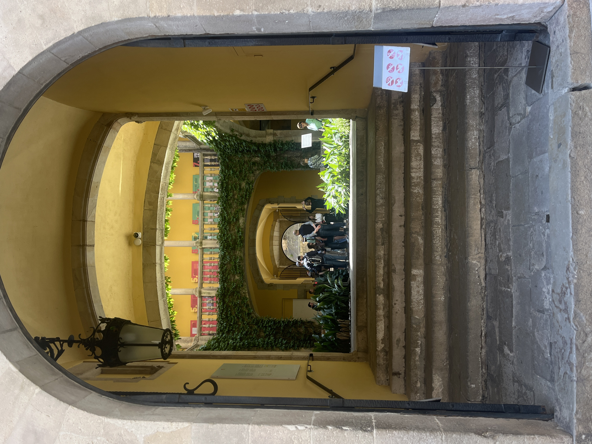 Tourist explores Barcelona's Gothic Quarter, documents historic architecture