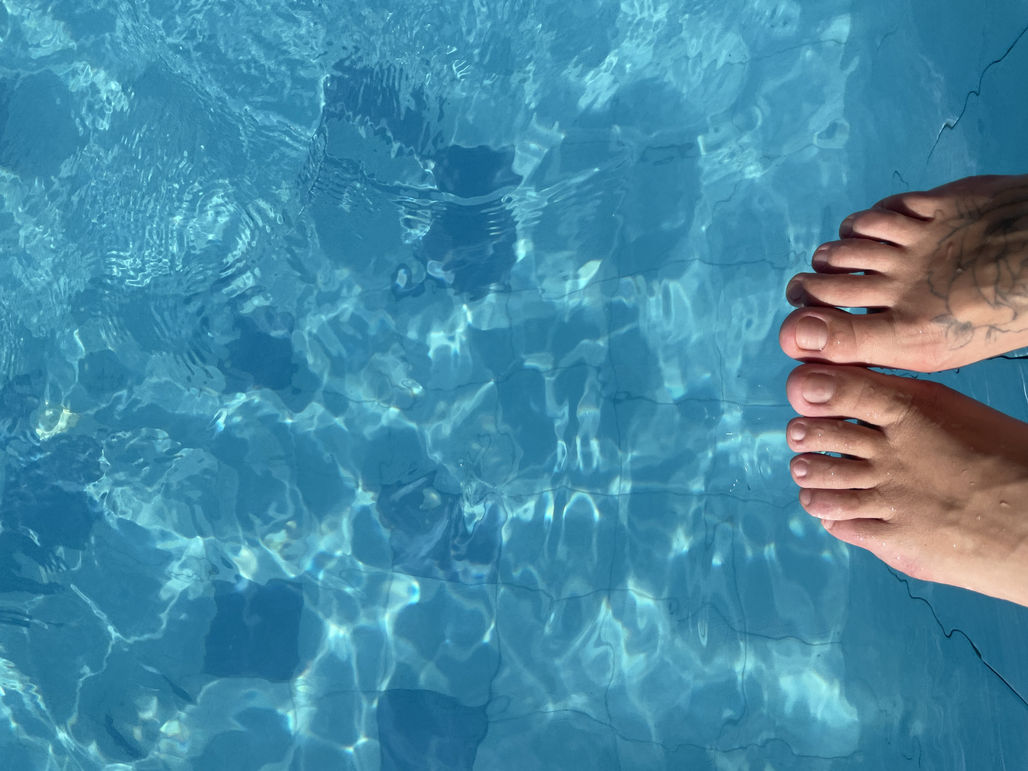 Summer afternoon in Budva: pools, parasailing, and street scenes.
