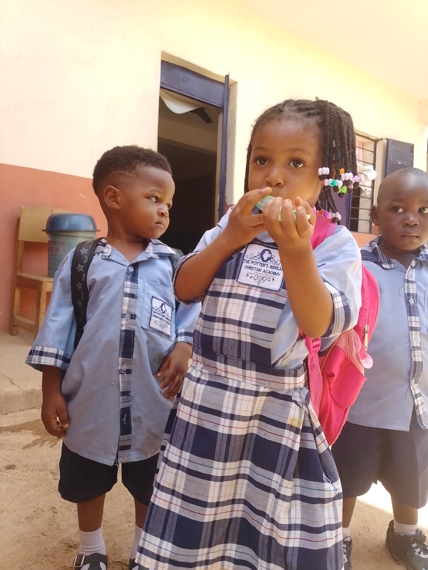 Students photographed in school uniforms at outdoor location