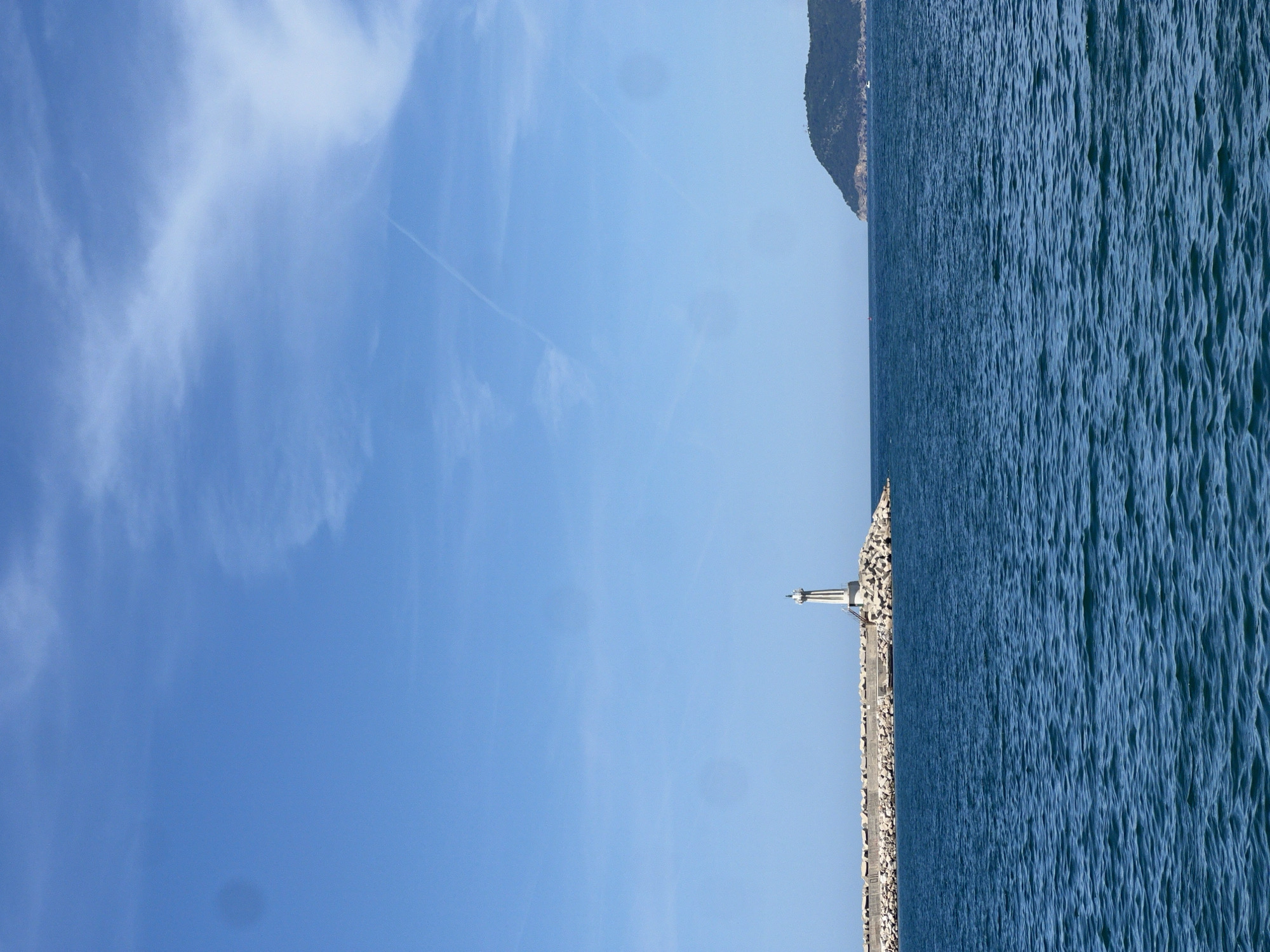Woman poses on anchor benches at Montenegro coastal promenade