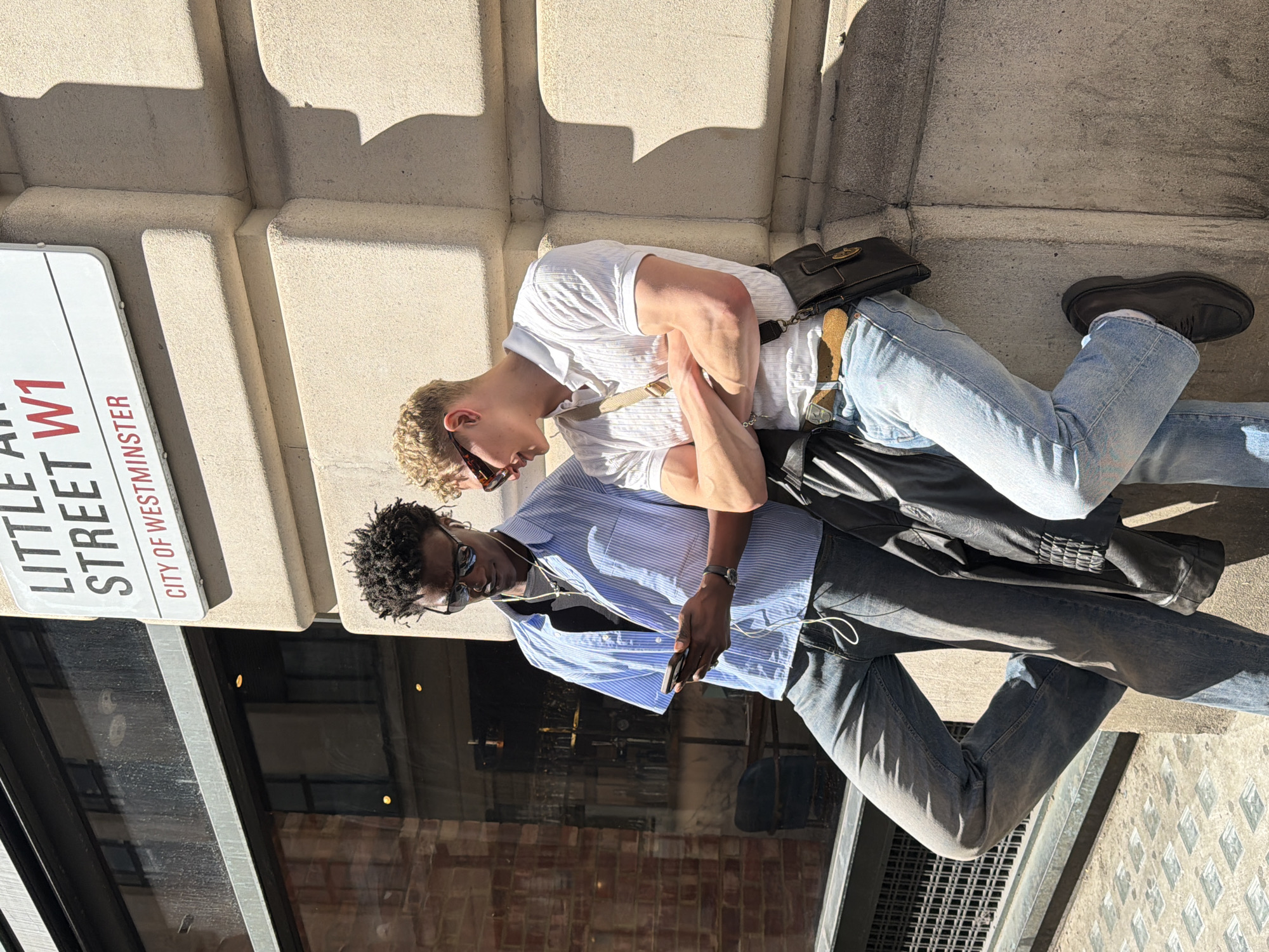 Two young men photographed outside London building