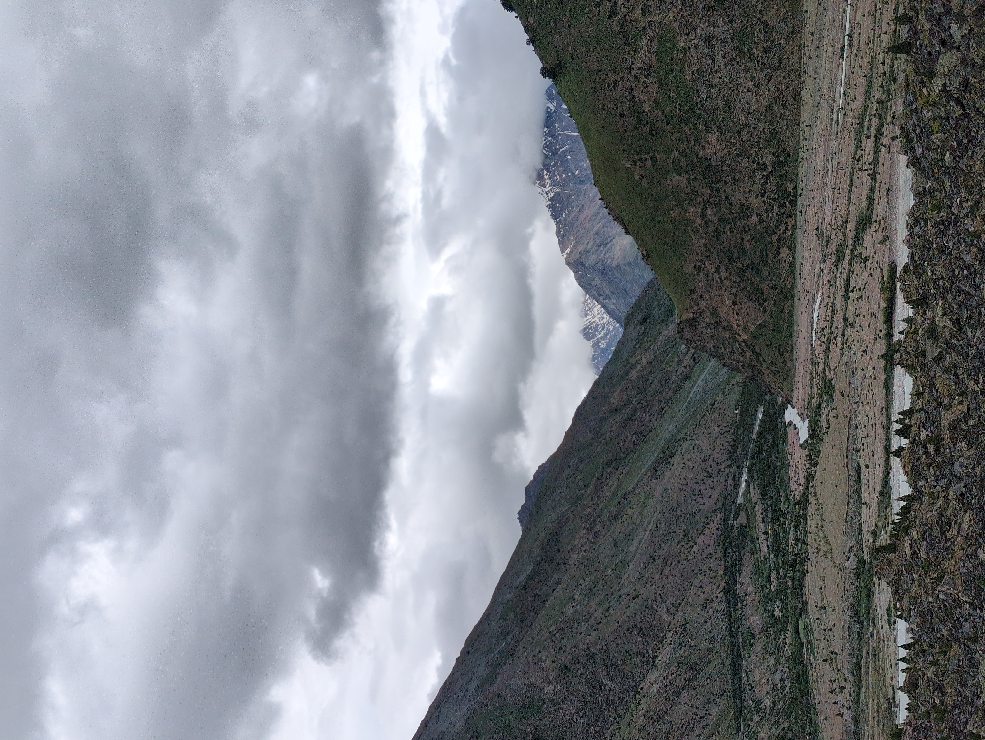 Rocky river valley cuts through overcast mountain terrain in Darcha
