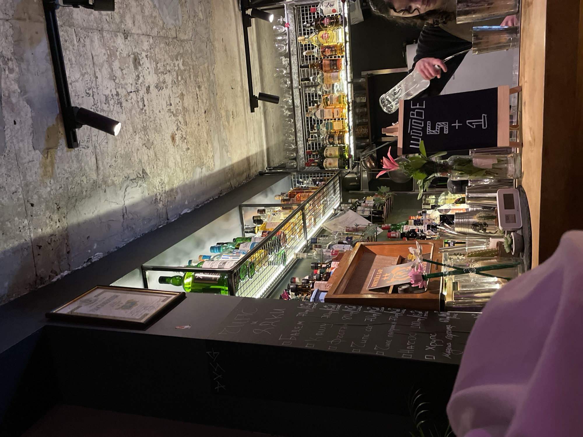 Evening patron documents drinks and comics at Bulgarian bar