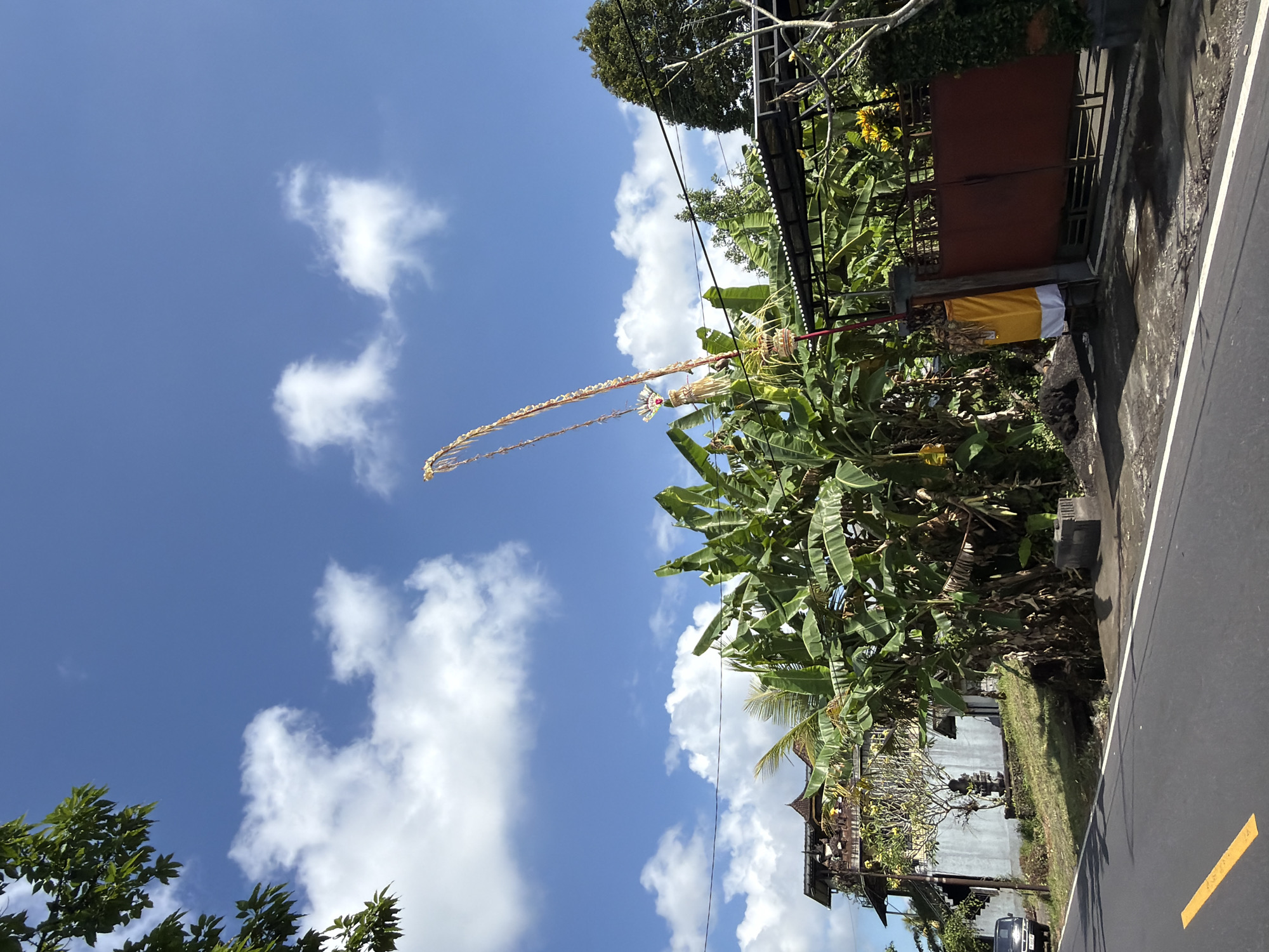 Tampaksiring street lined with Balinese temples and festival decorations