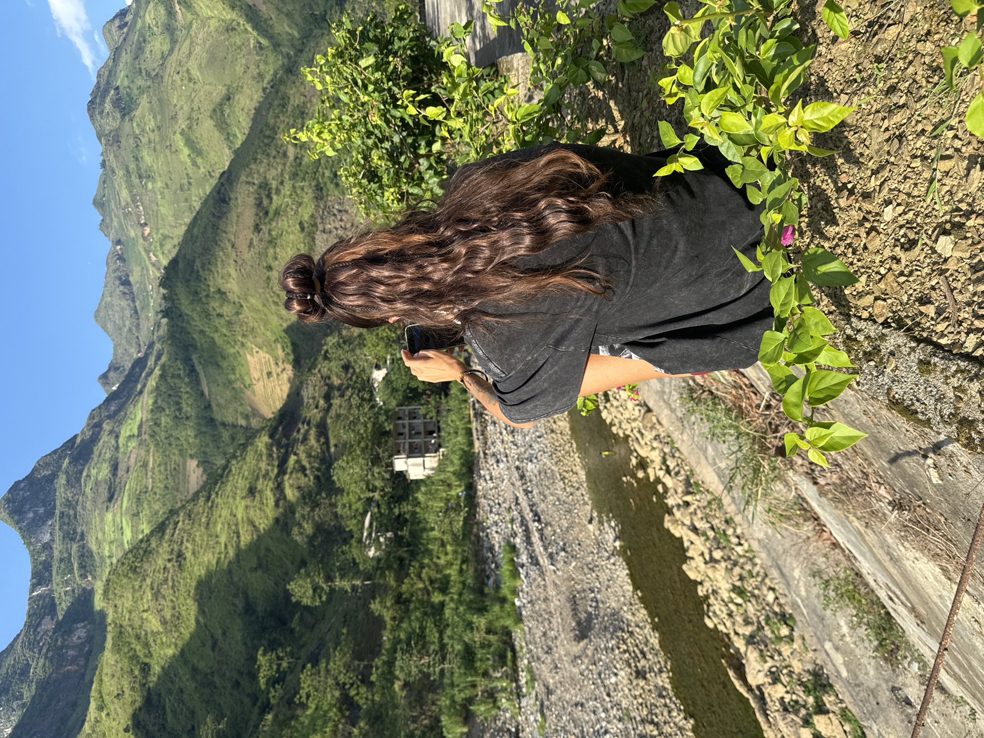 Tourists photograph scenic dam overlook in Vietnamese mountains