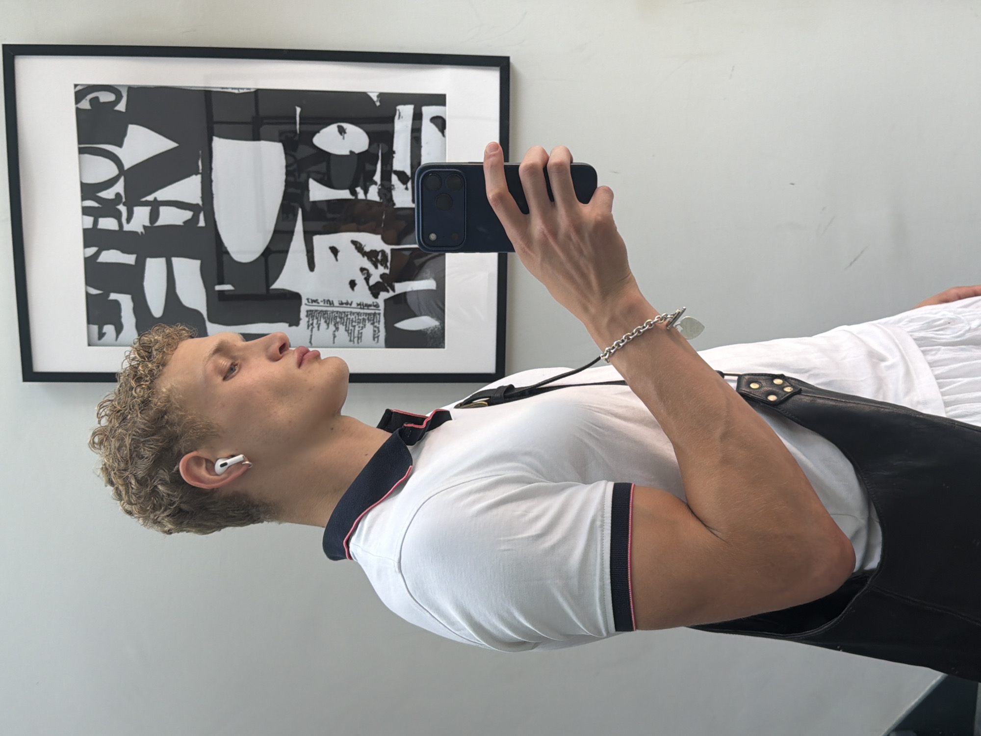 Selfie moment in London, white polo and smartphone in hand