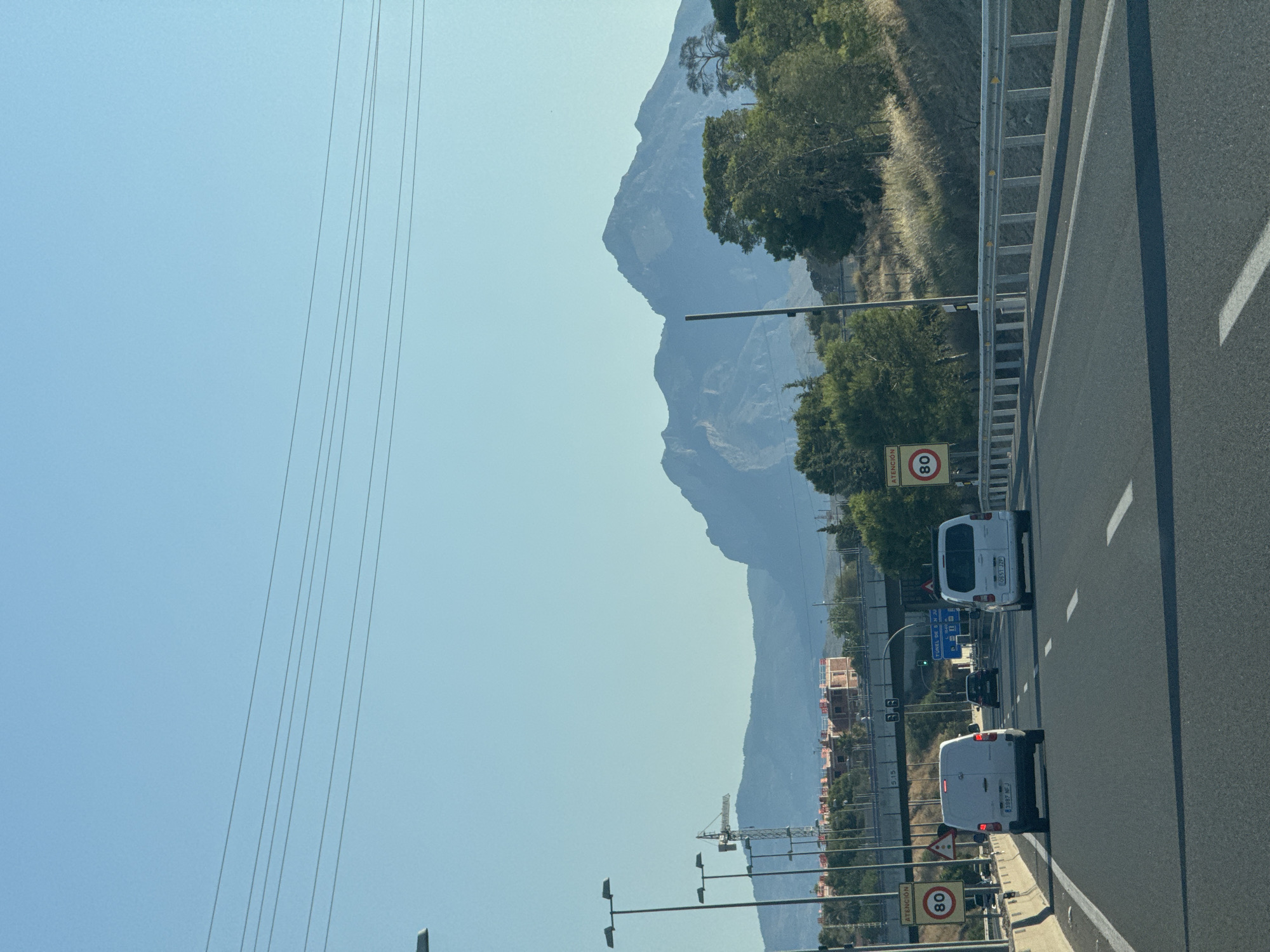 Open highway cuts through dramatic mountain scenery near Lloixa