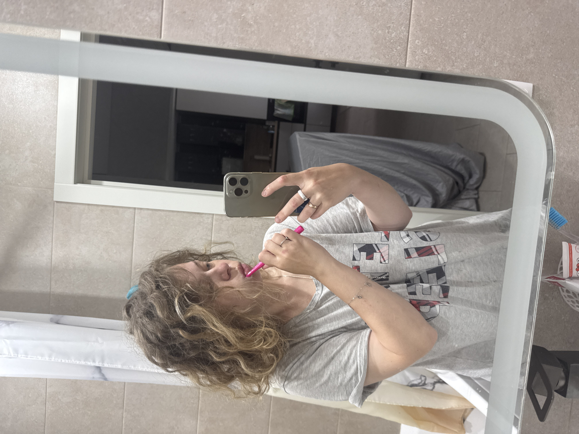 Morning bathroom routine in Mikhaylovsk, multitasking with phone