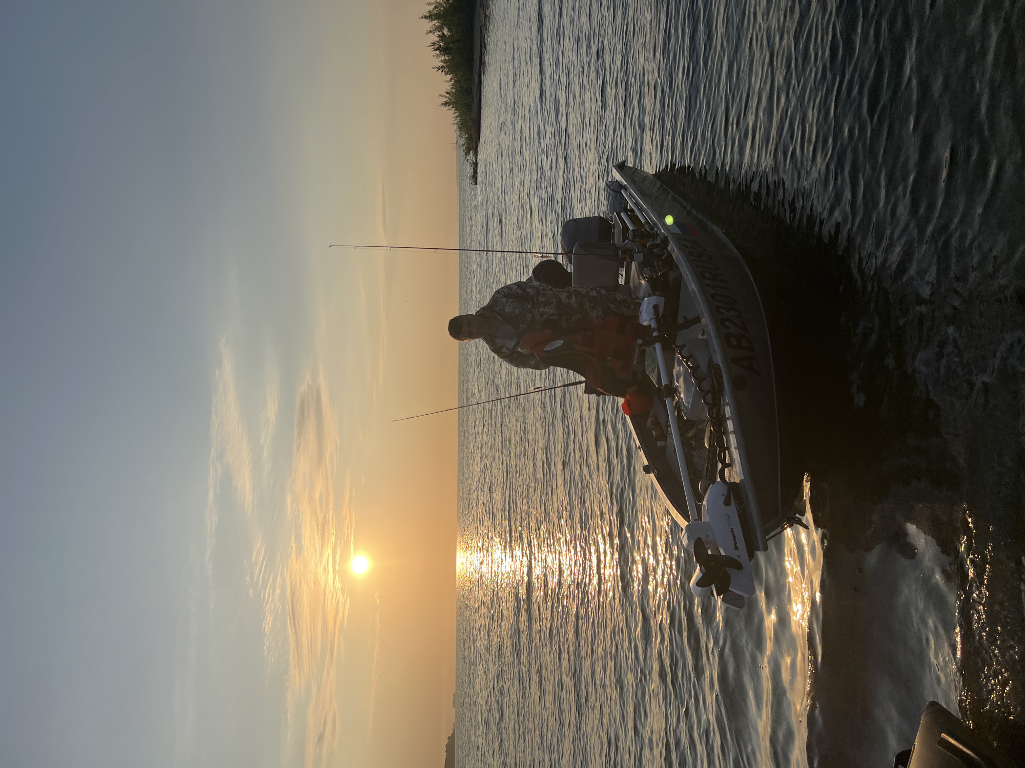 Fishing boat at sunset on the water near Borovoye, Russia