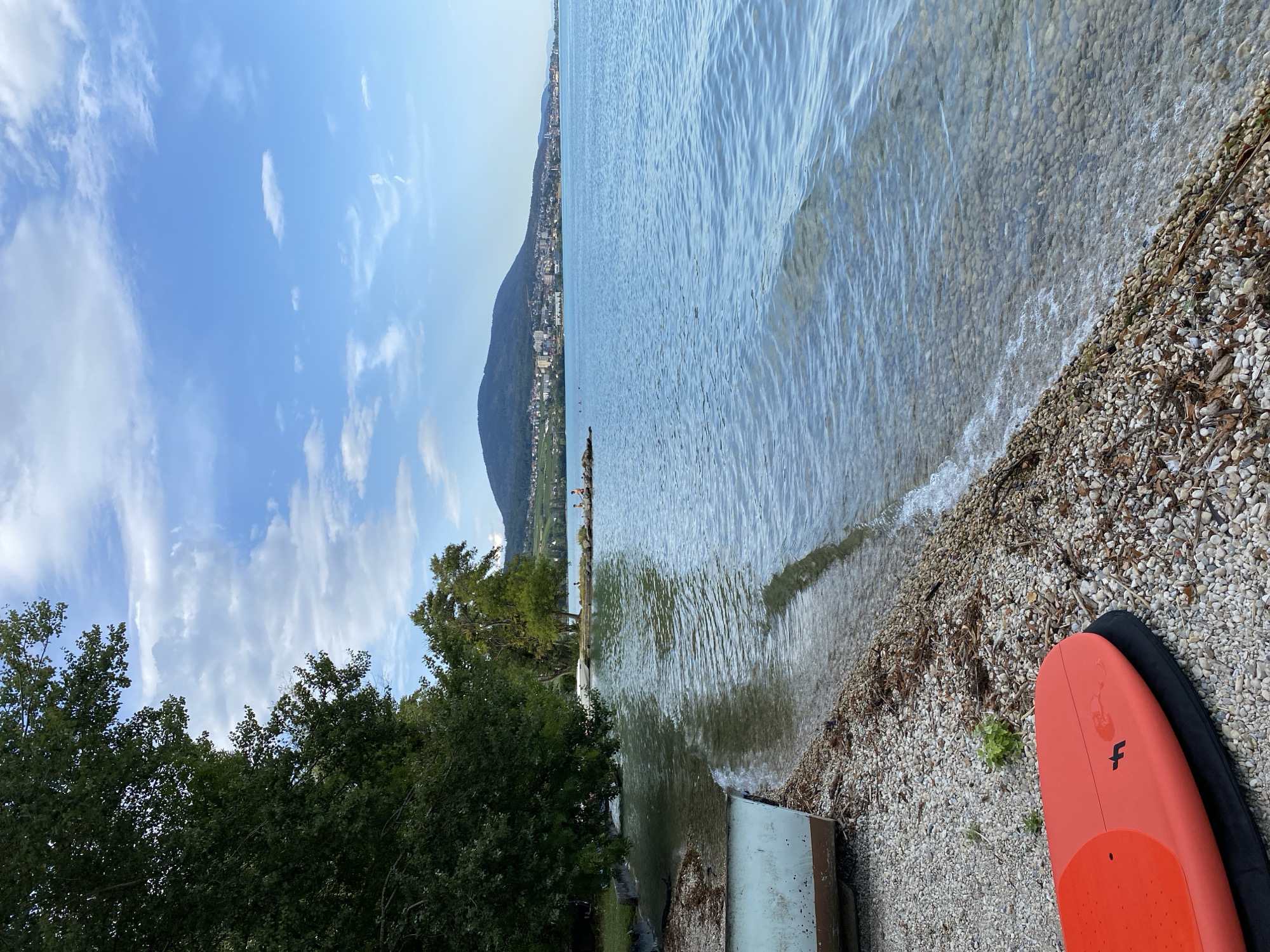 Quiet lakefront afternoon in Milvignes, Jura Mountains in view