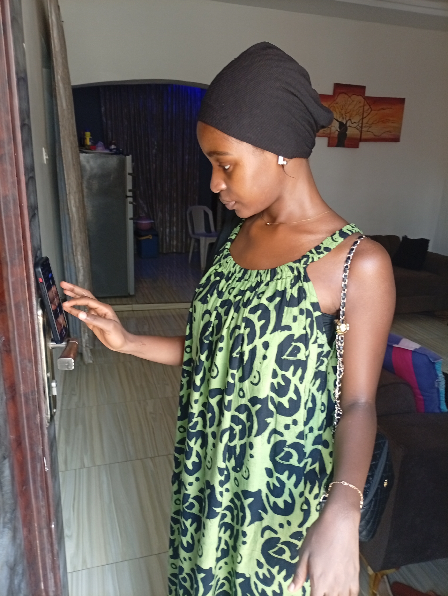 Woman uses smartphone door device at residential location